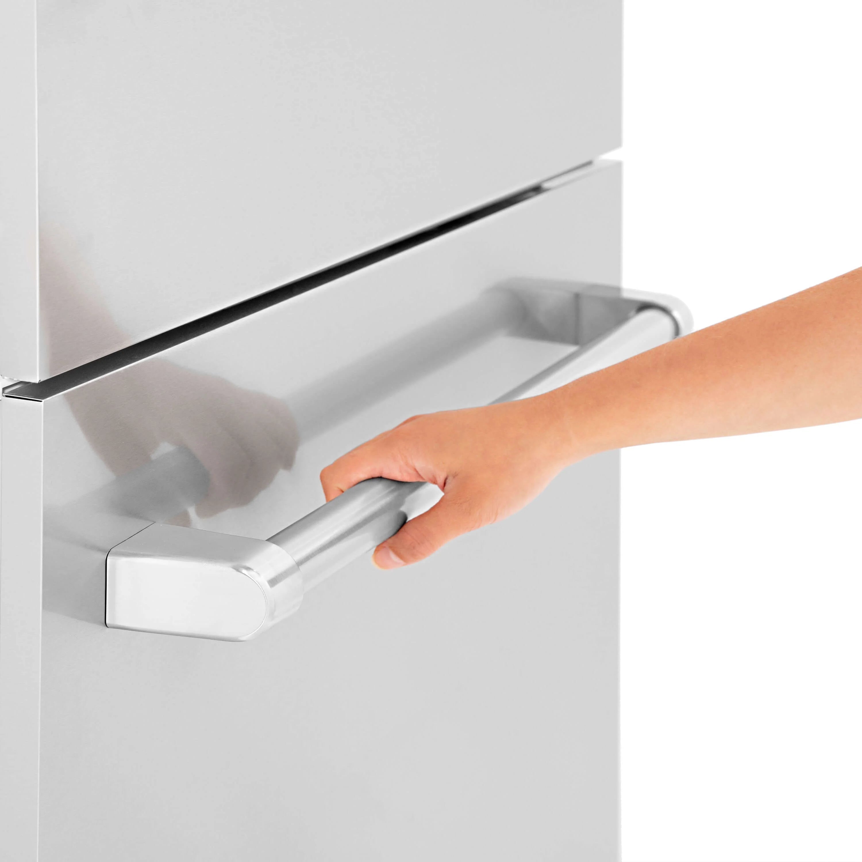 Stainless steel refrigerator handle being attached to a cabinet panel