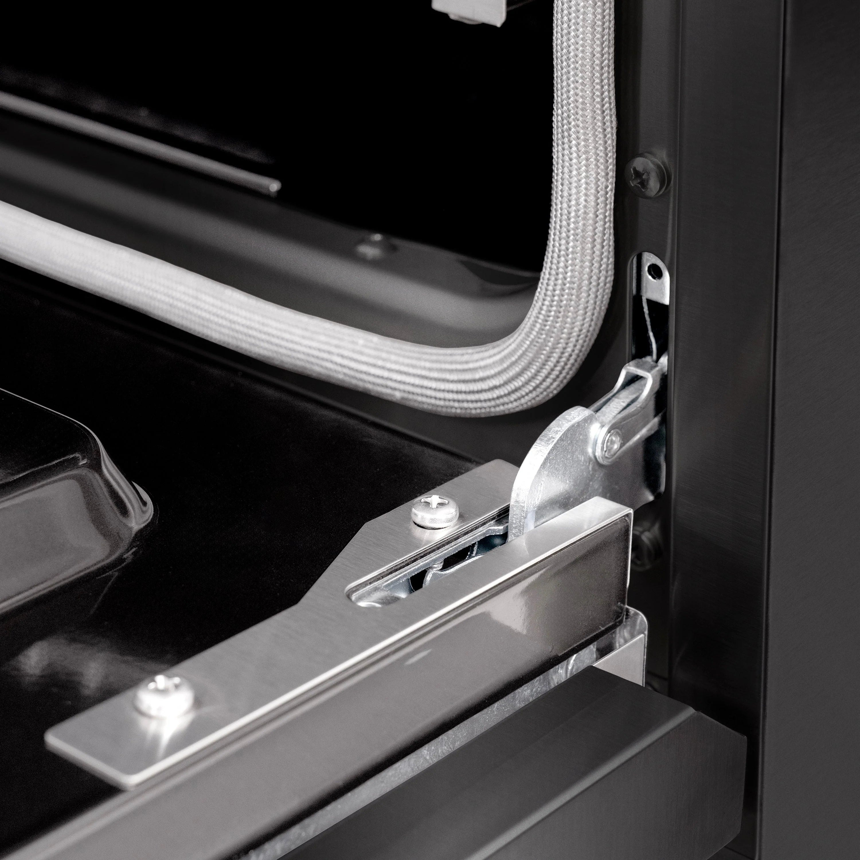 Black gas range oven door hinge and latch hardware detail