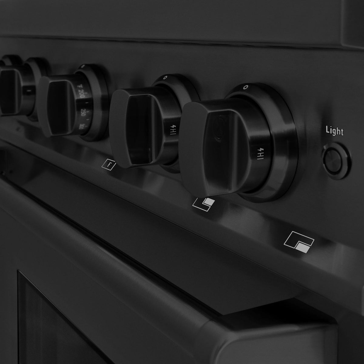 Black control panel with round burner knobs and Light setting