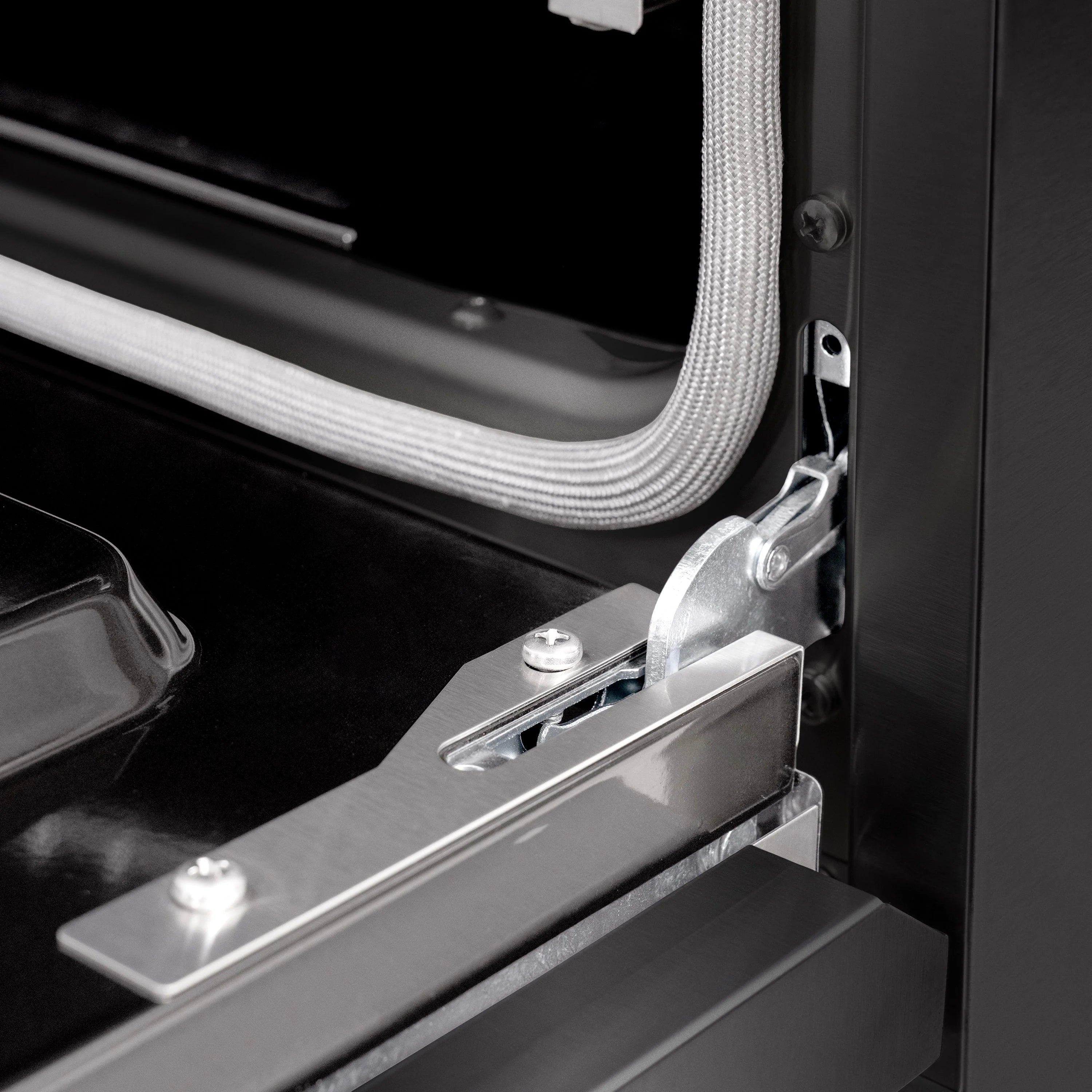 Black dual-fuel range door hinge and champagne bronze handle with rubber trim edge