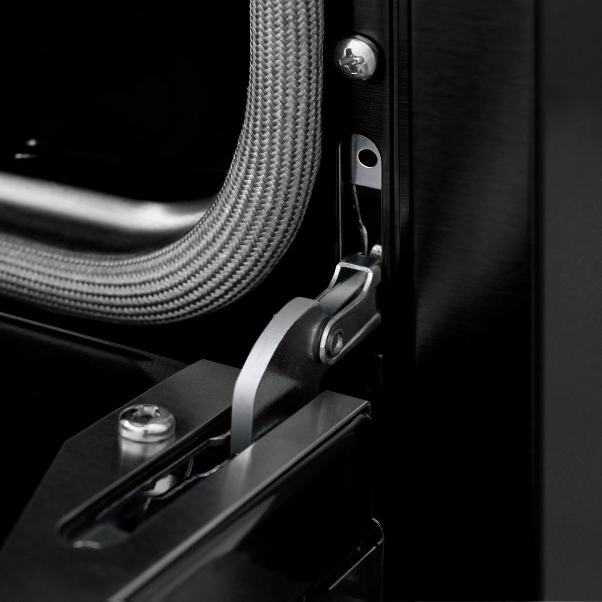 Black stainless gas range door handle and control hardware detail