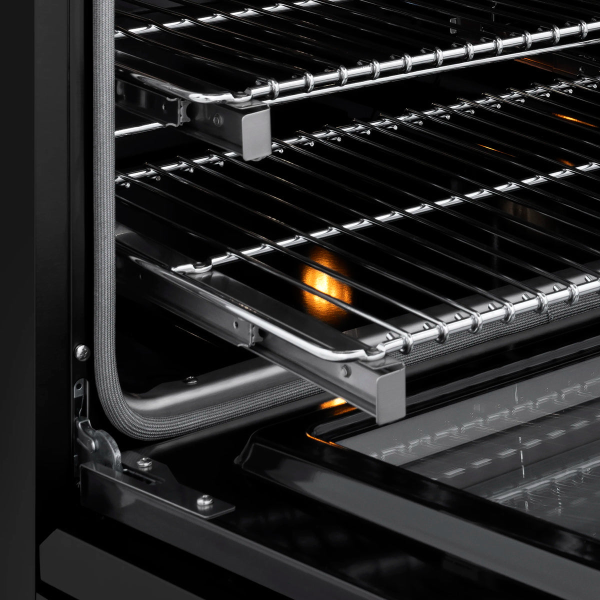 Open gas oven with glowing burner and wire rack