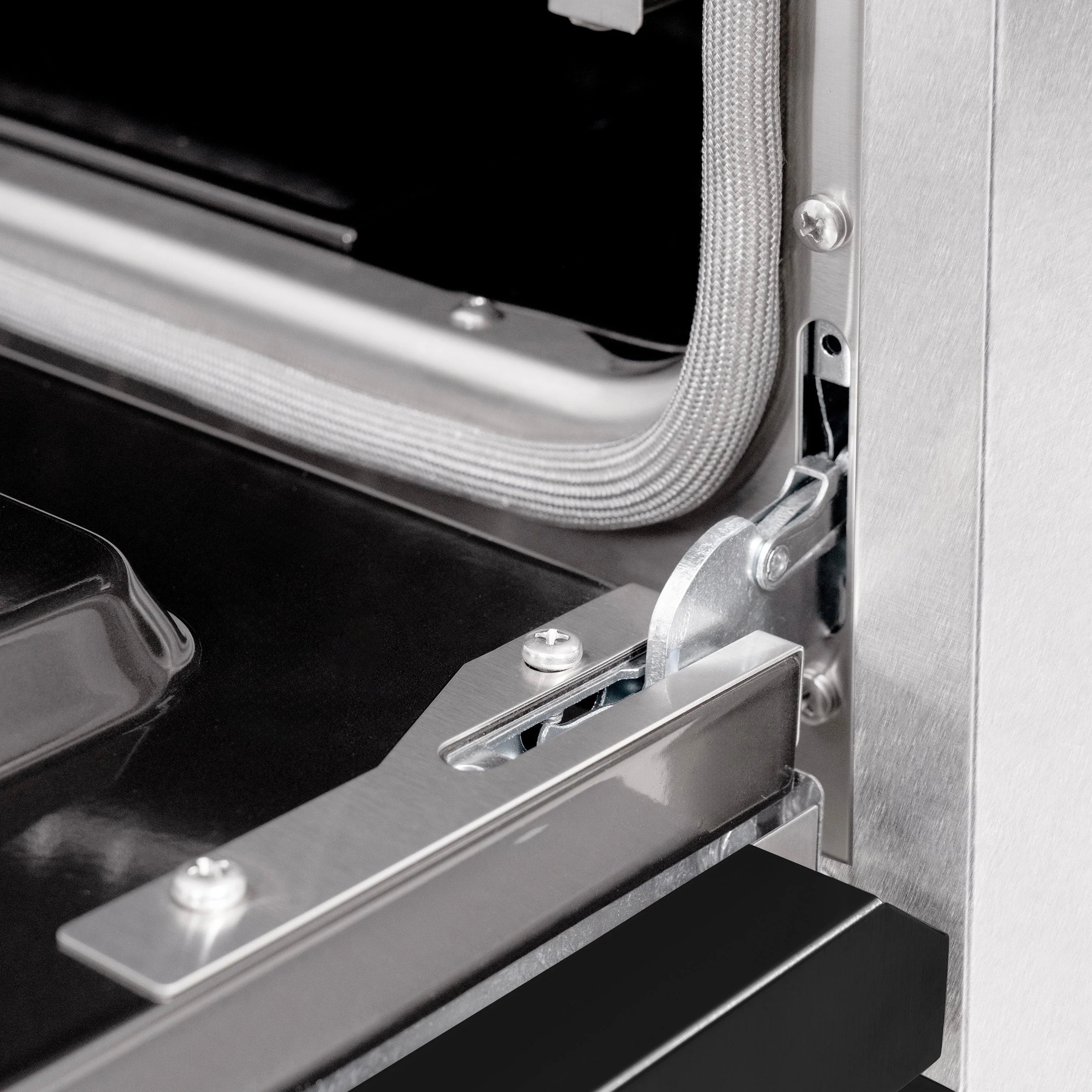 Oven door latch and hinge hardware on stainless range side