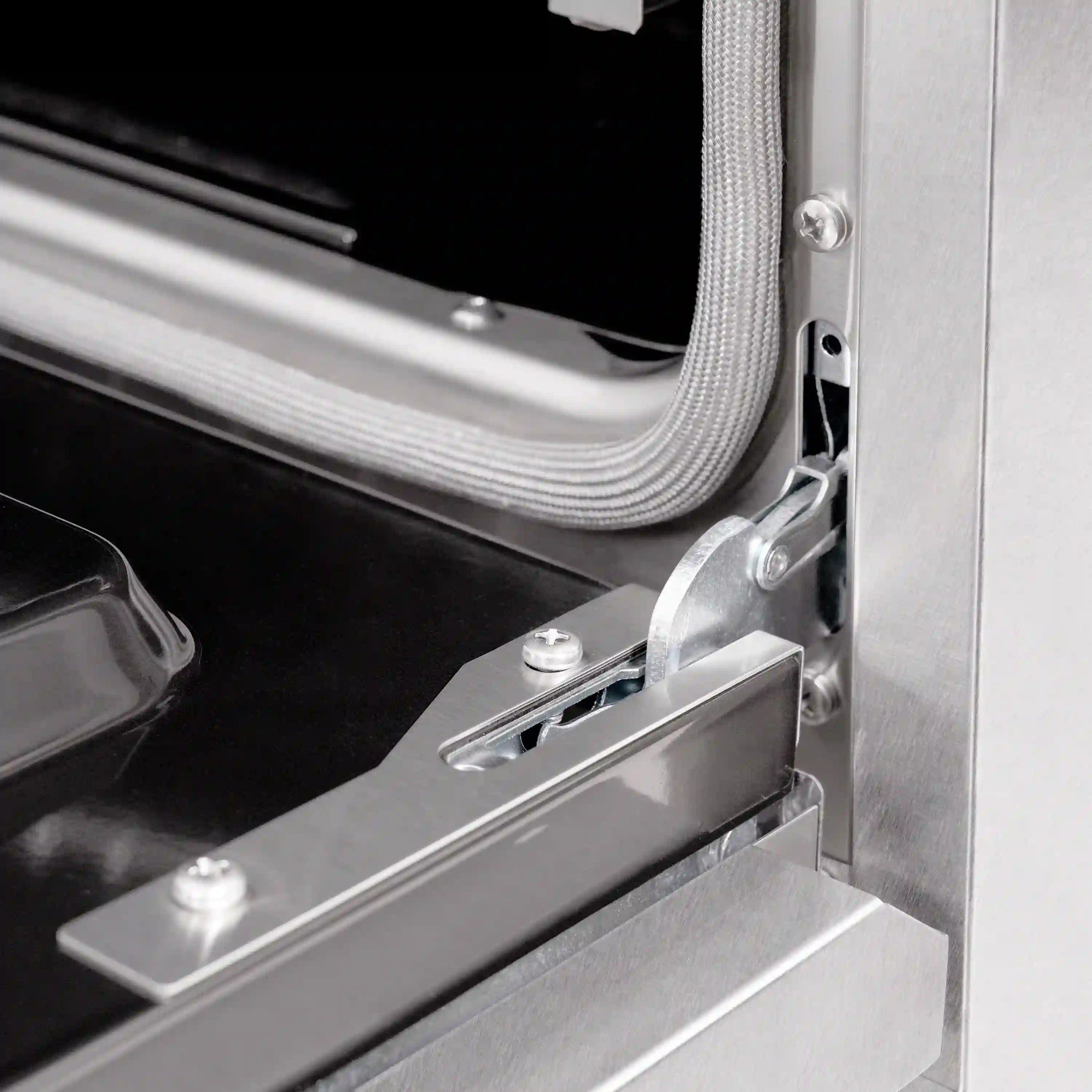 Stainless oven door hinge and mounting bracket detail