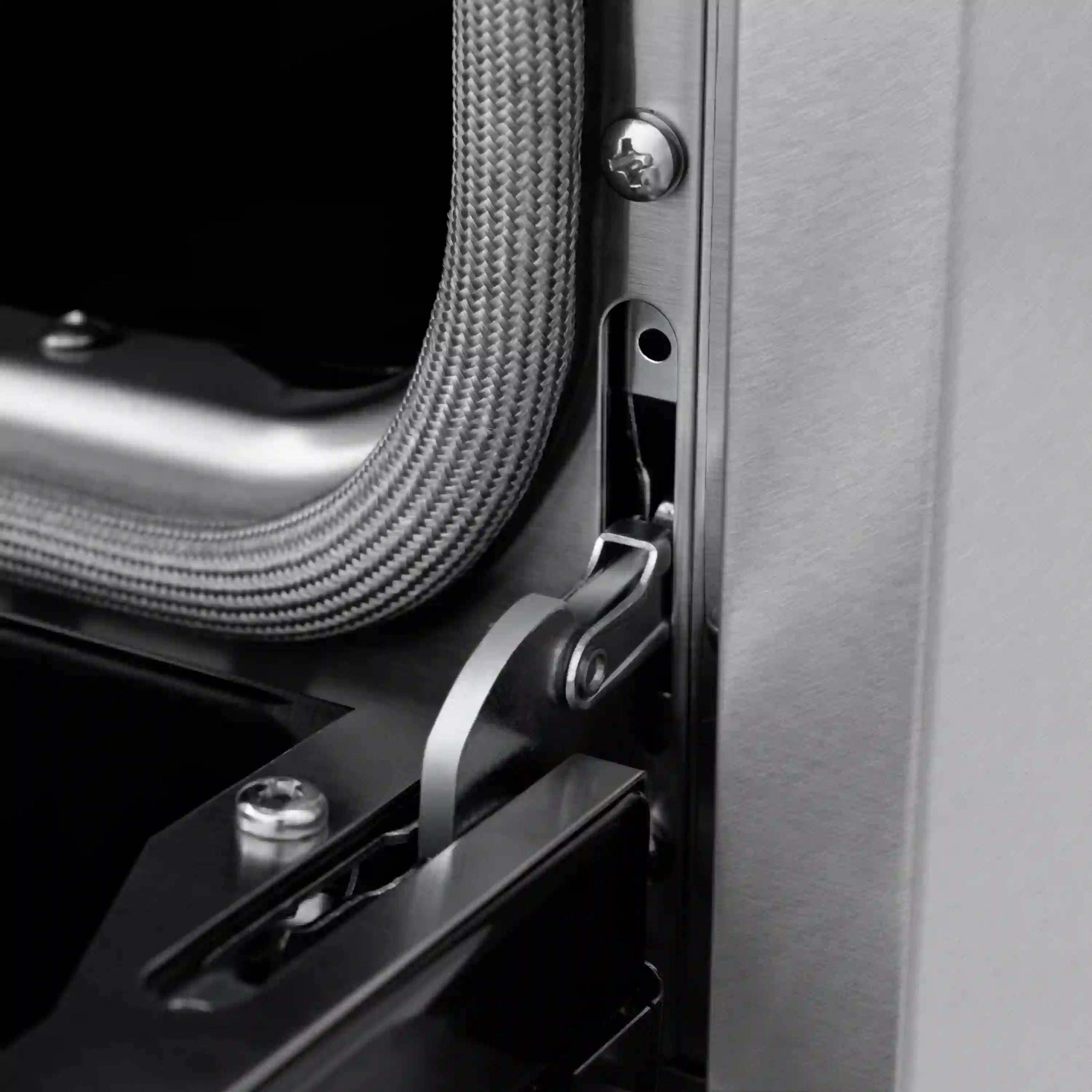 Dual fuel range side connection area with braided cable and stainless trim