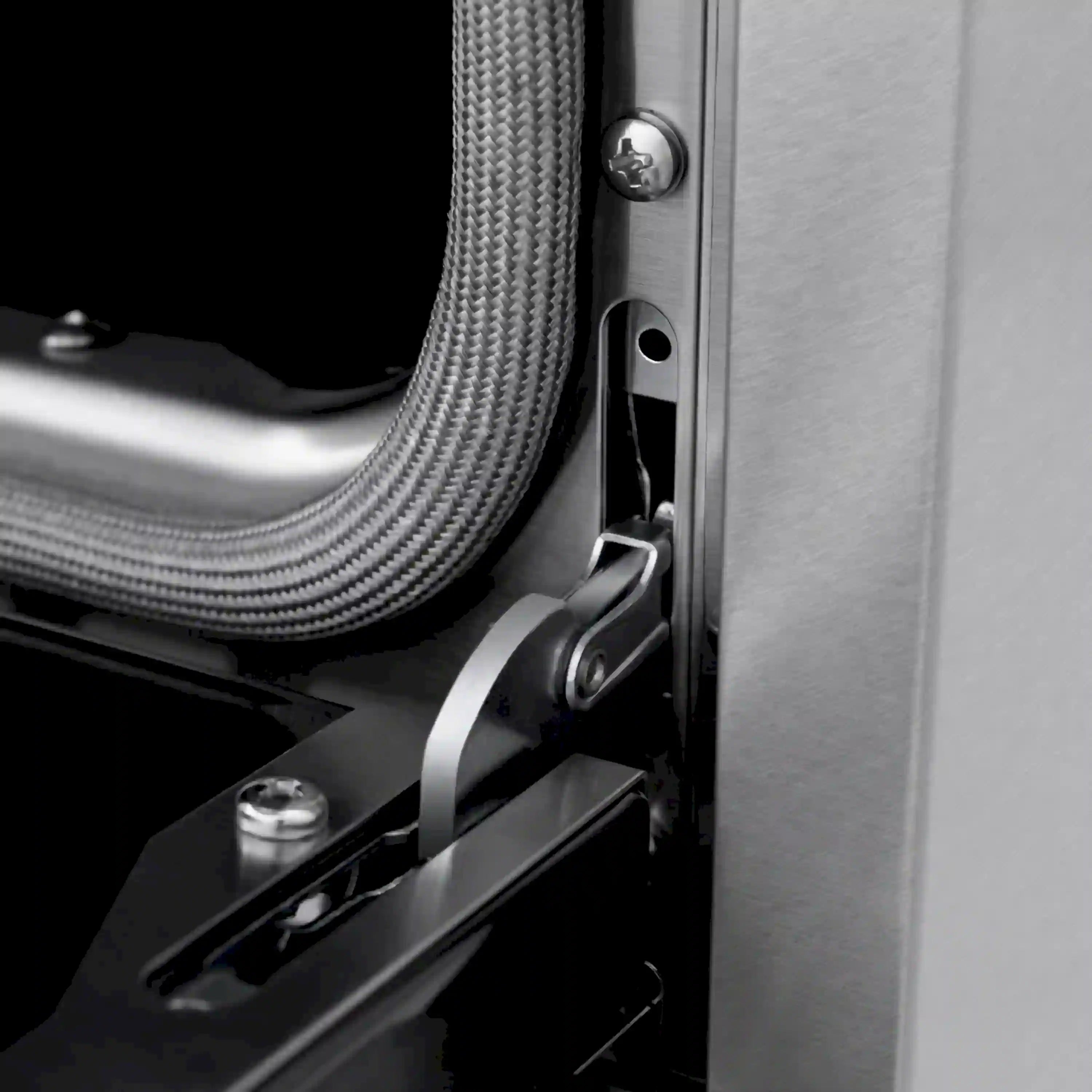 Stainless steel range side detail with mounting hardware and black gasket edge