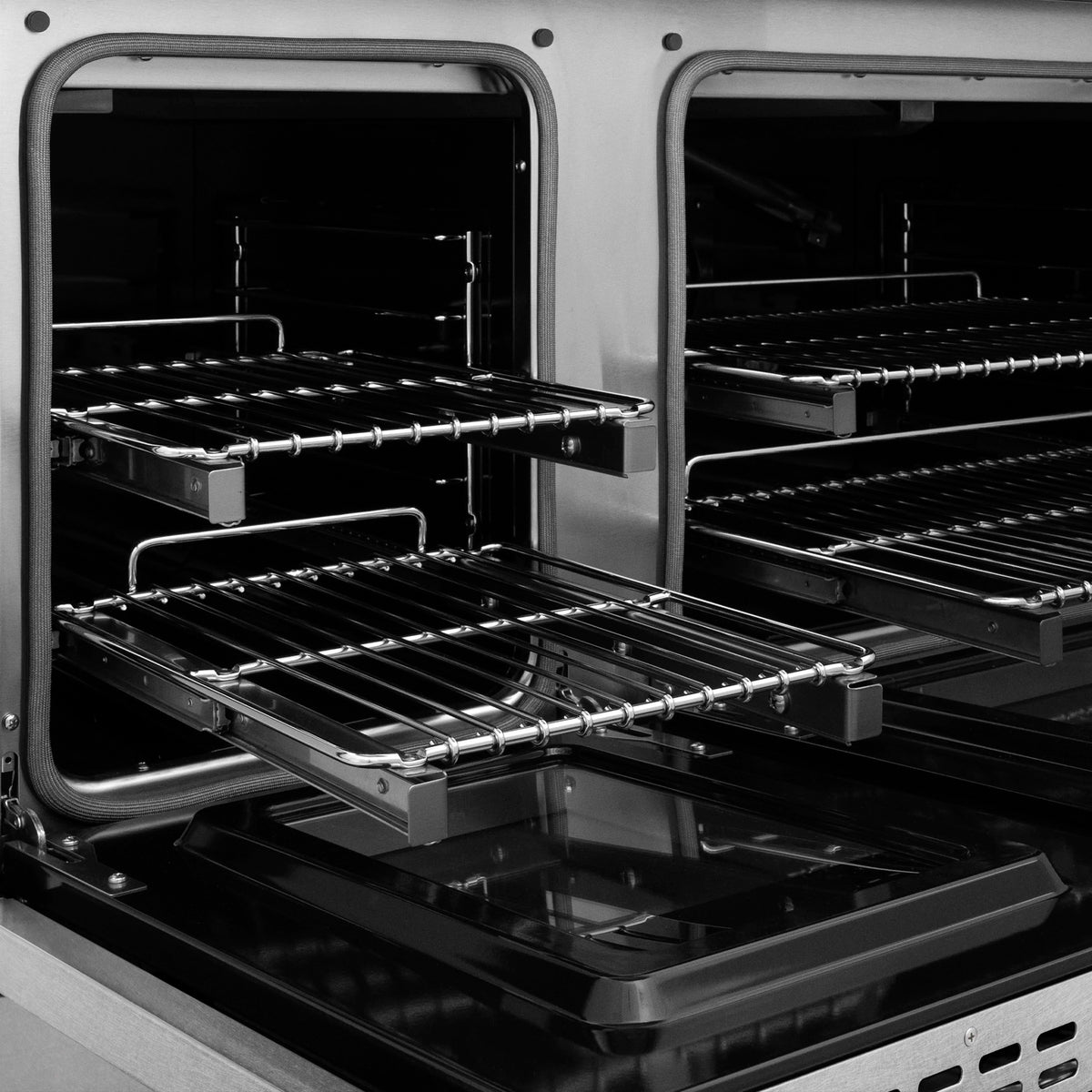 Dual oven interior with wire racks and broiler support in a black cavity