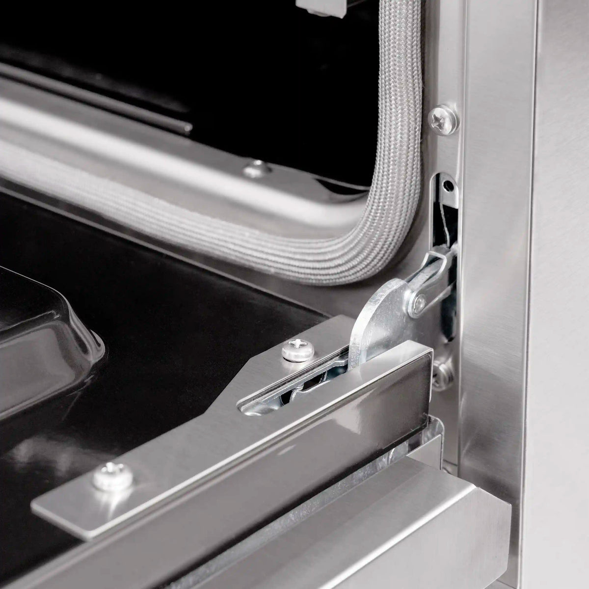 Dual fuel range oven door hinge and latch hardware on stainless steel frame