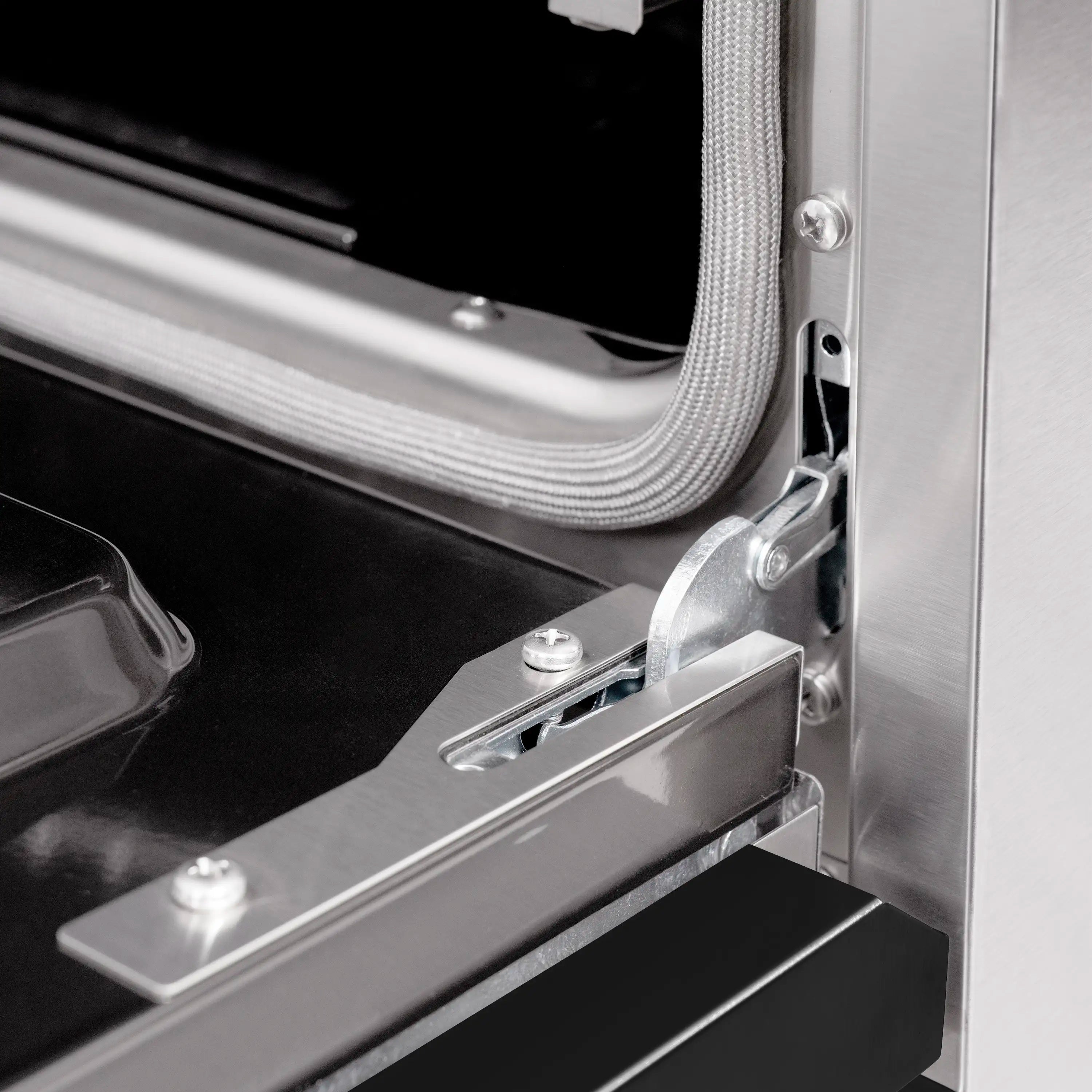 Oven door hinge and latch hardware on stainless steel gas range