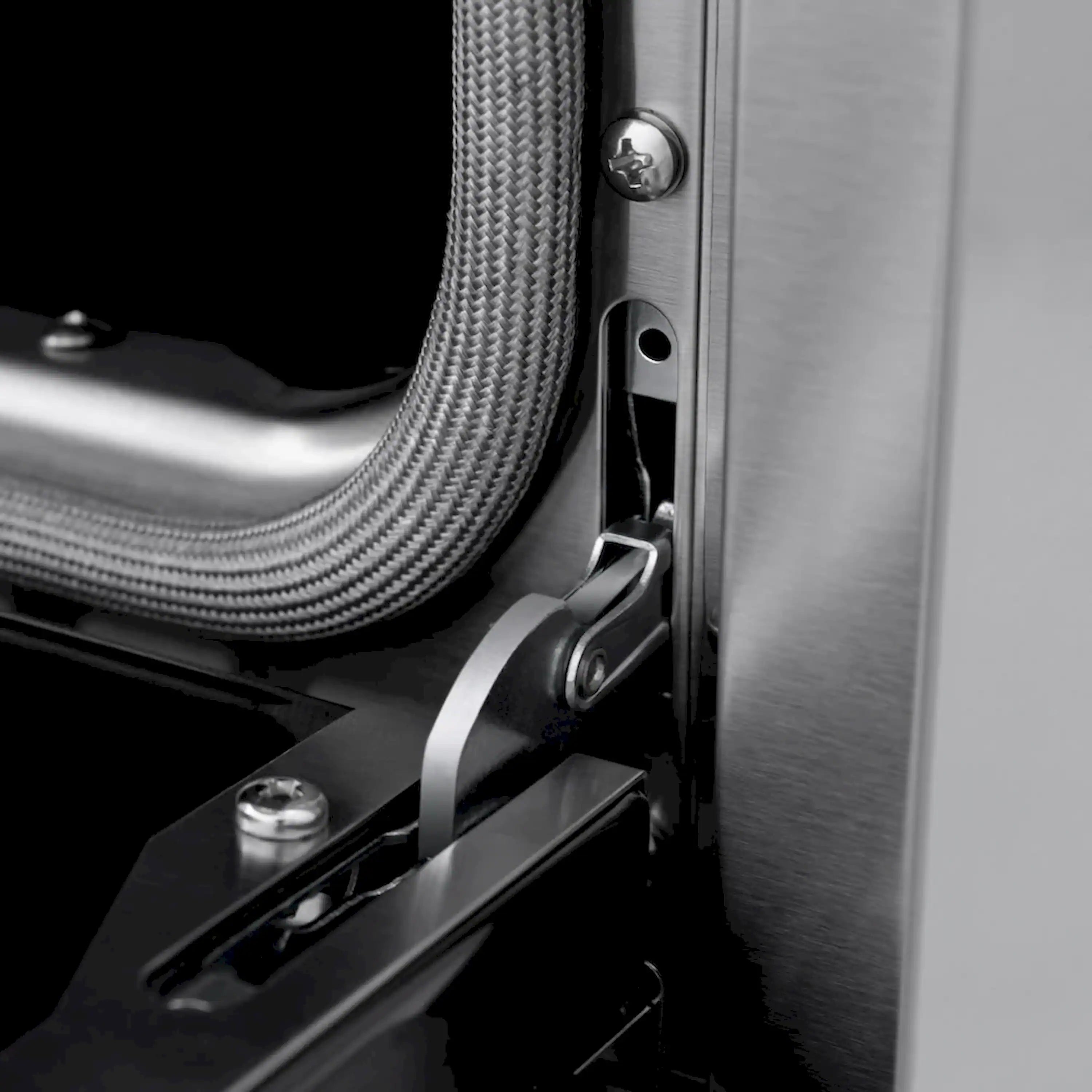 Stainless steel gas range side detail with flexible gas line and connector