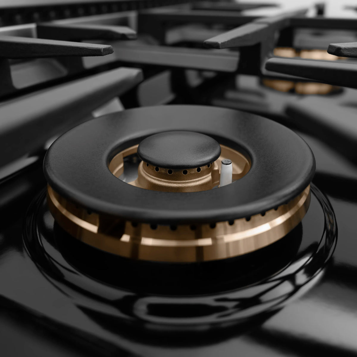 ZLINE dual fuel range single burner close-up with black cap and brass burner base