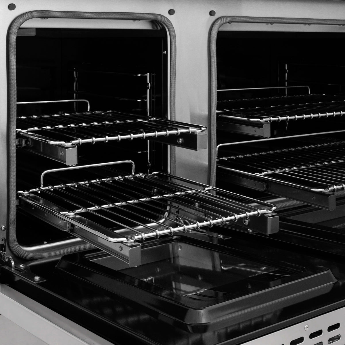 Dual fuel range oven interior with black racks and wire shelves in both compartments.