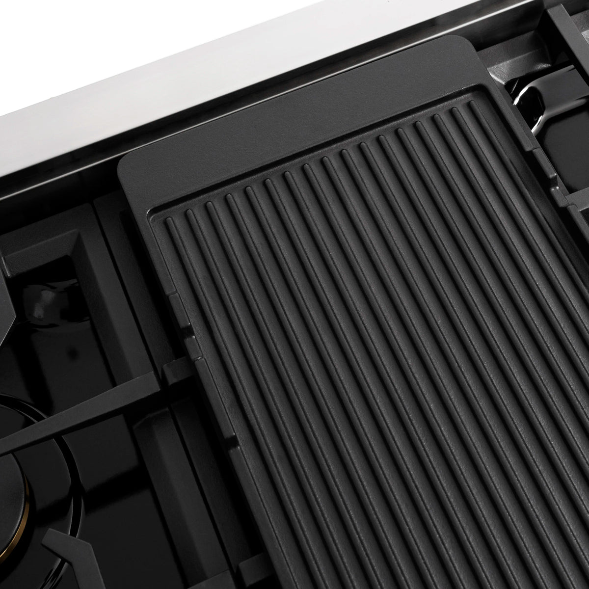Black gas griddle with ribbed surface, inset in black stovetop frame