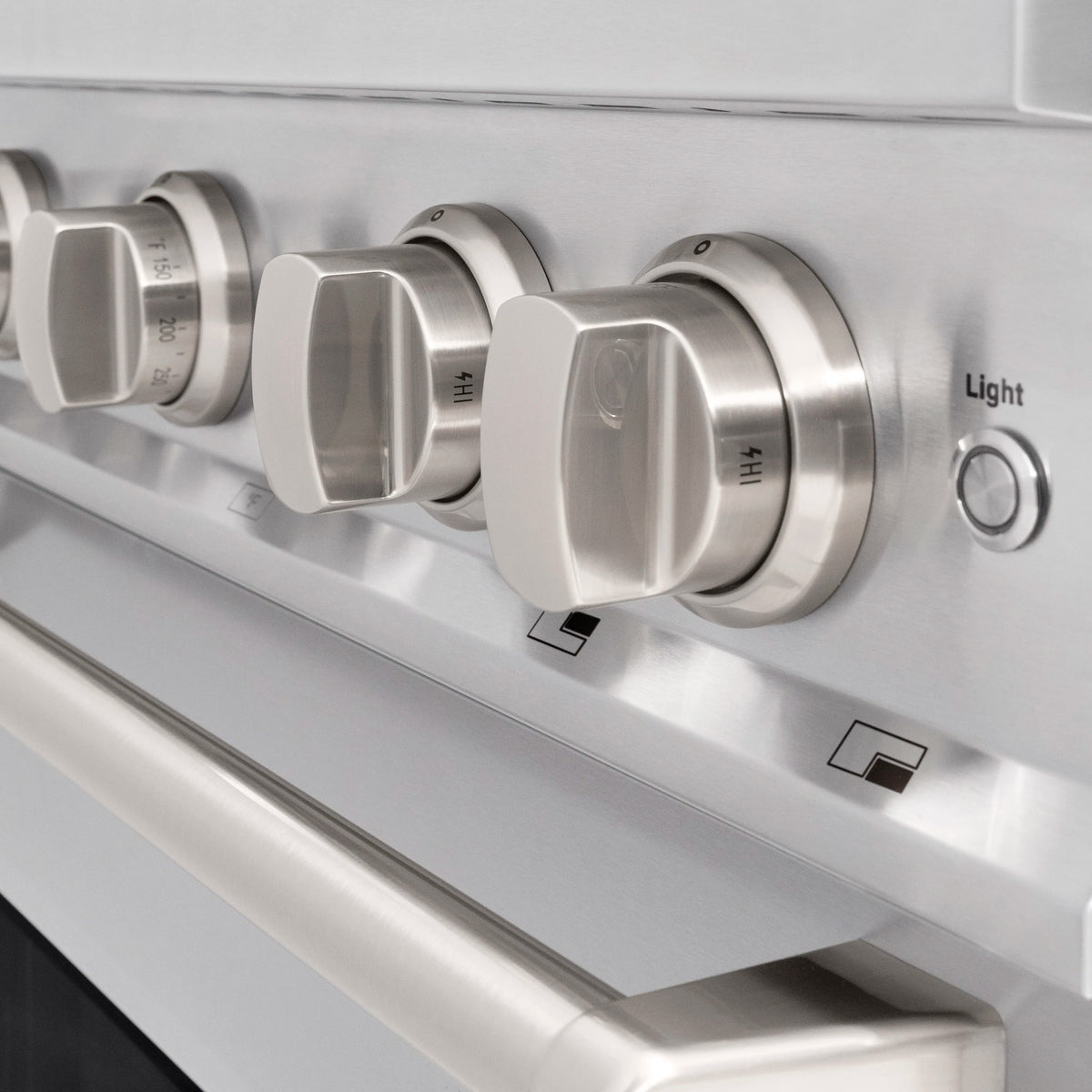 Stainless steel range control panel with four knobs and a Light switch