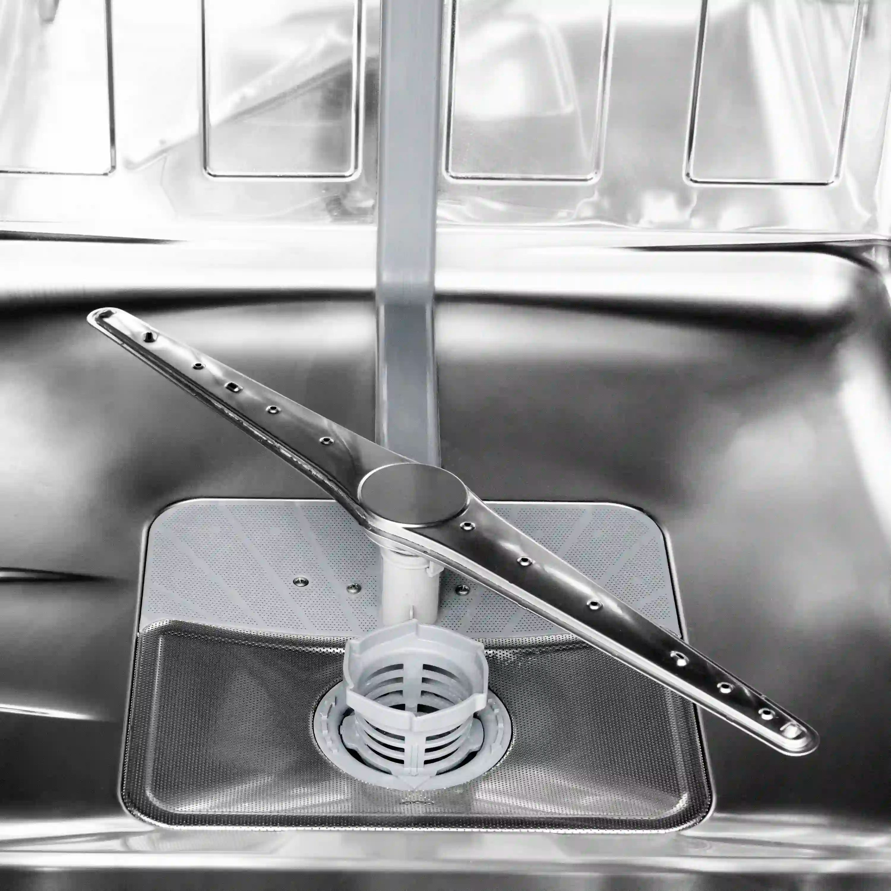 Dishwasher wash area with stainless tub, drain filter, and spray arm