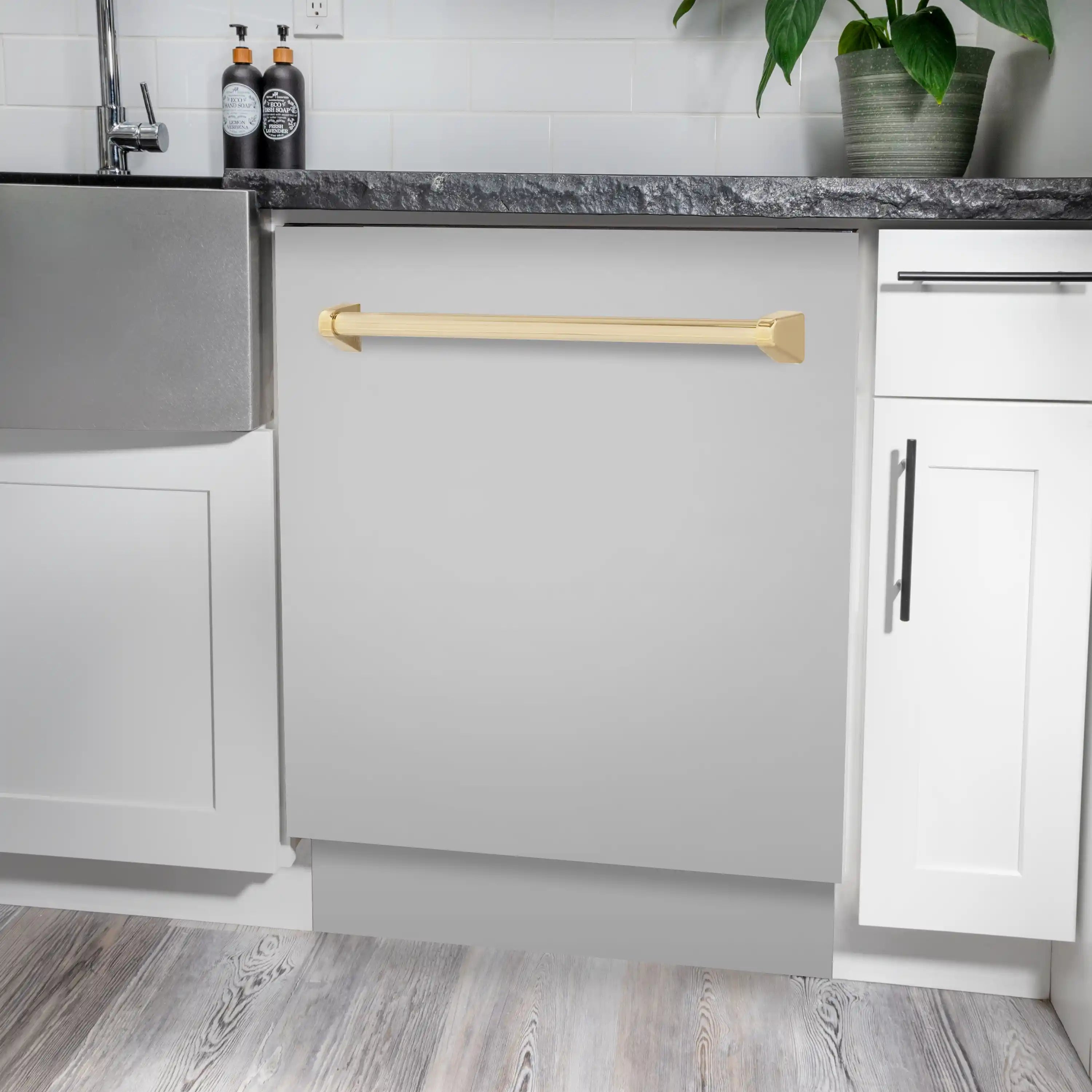 Built-in dishwasher with gold handle installed under kitchen countertop