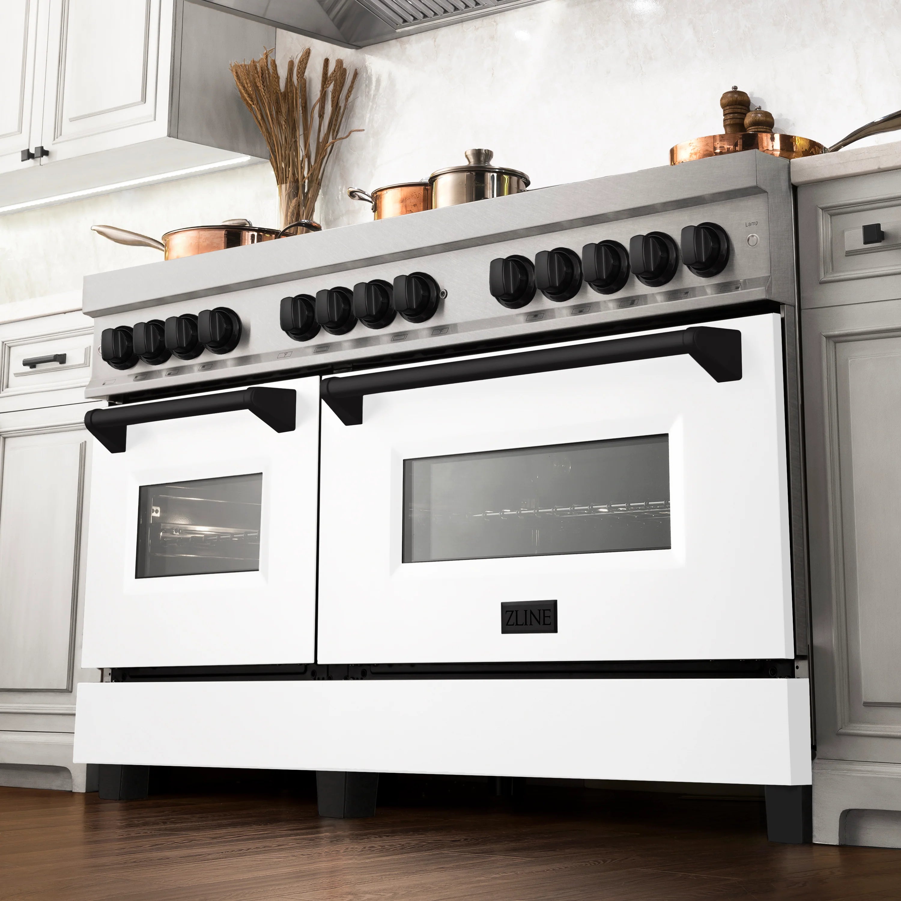 Dual fuel range front with white oven doors, black knobs, and burner grates