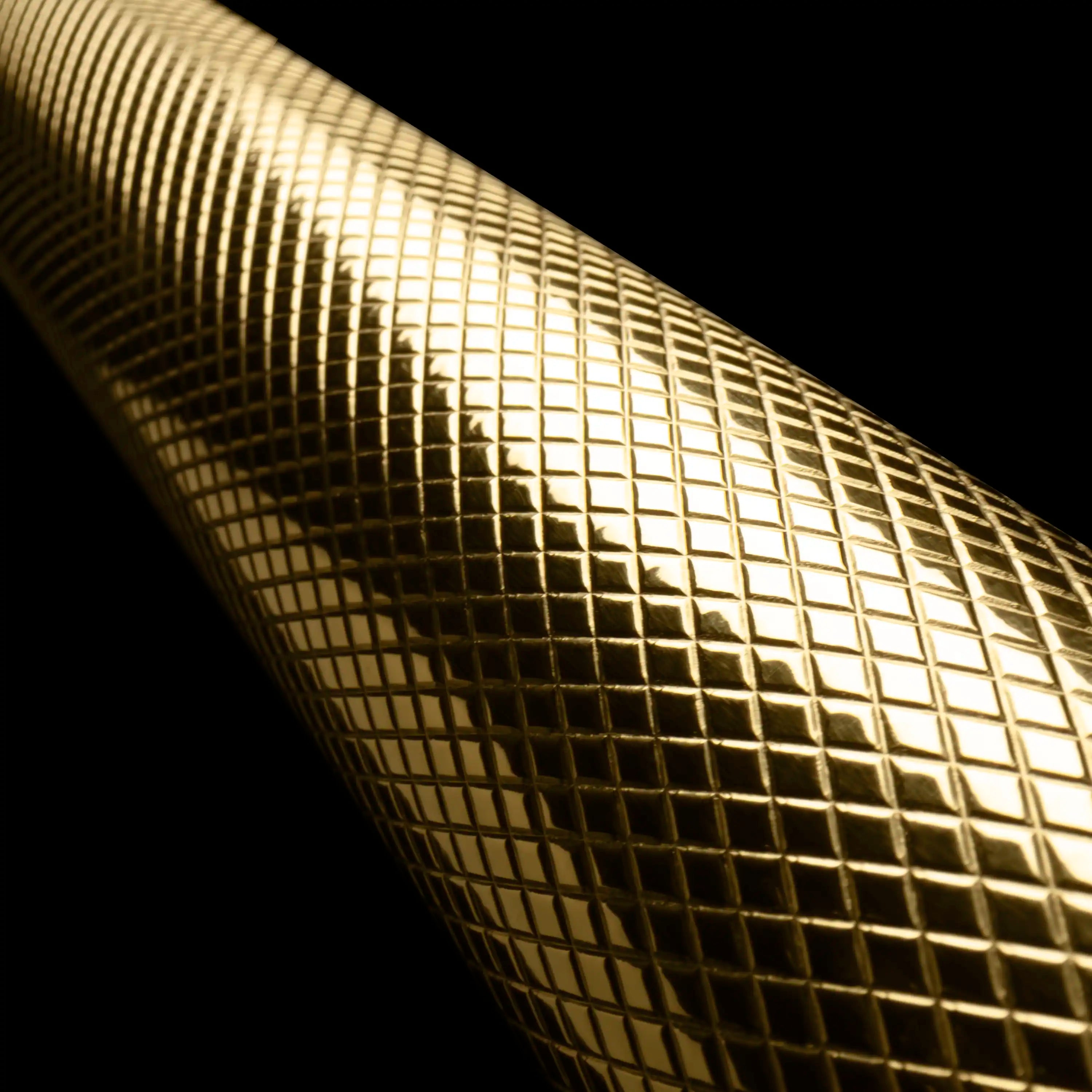 Refrigerator drawer gold helix handle close-up with textured mesh pattern