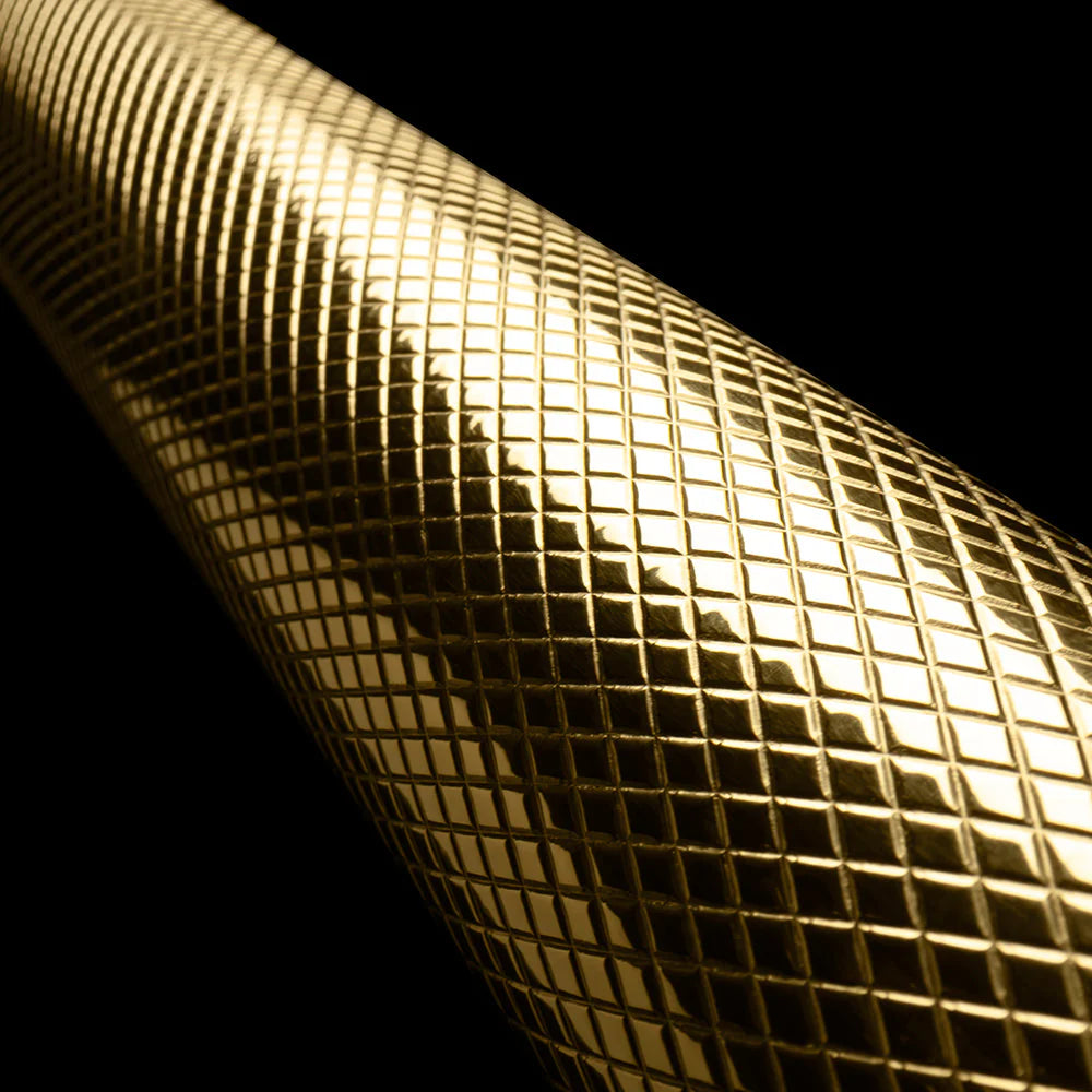 Polished gold helix handle detail on black gas range
