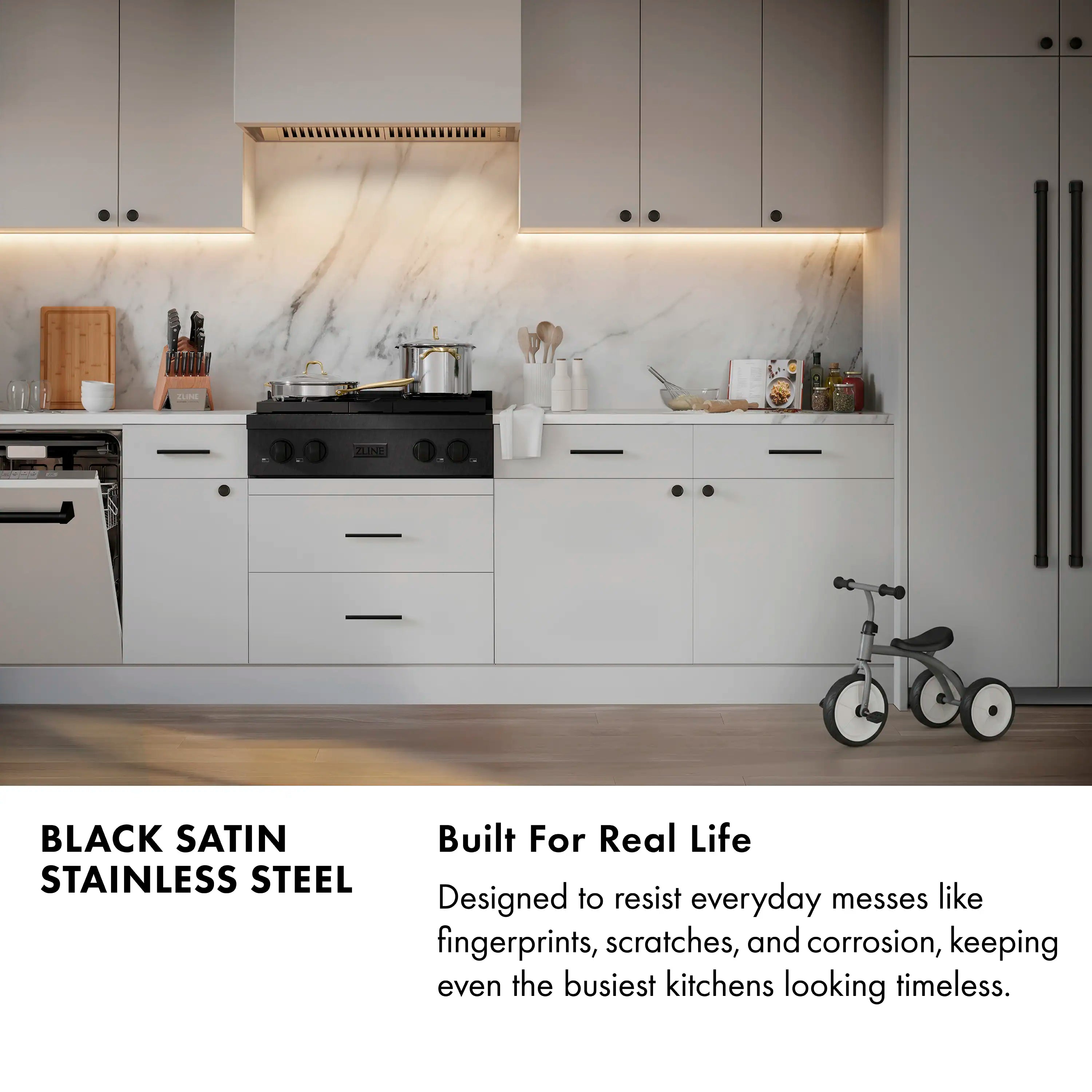 Black gas rangetop with champagne-accent knobs and grates, front view