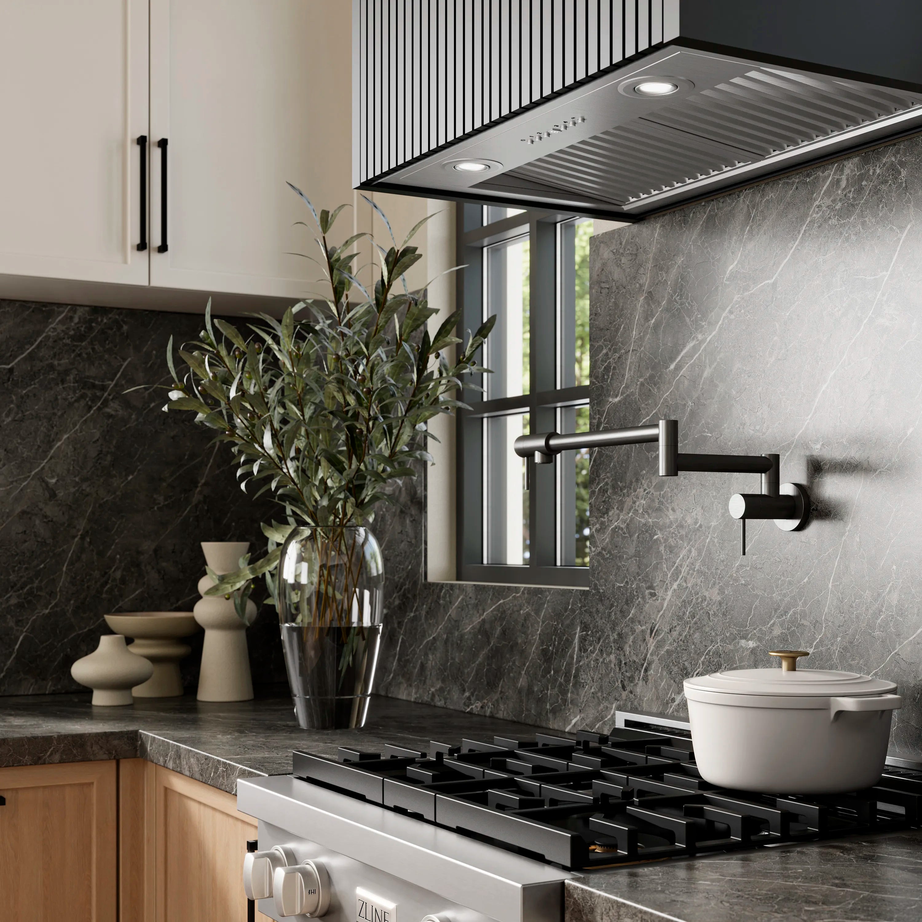 Stainless steel range hood insert with vent canopy above black cooktop