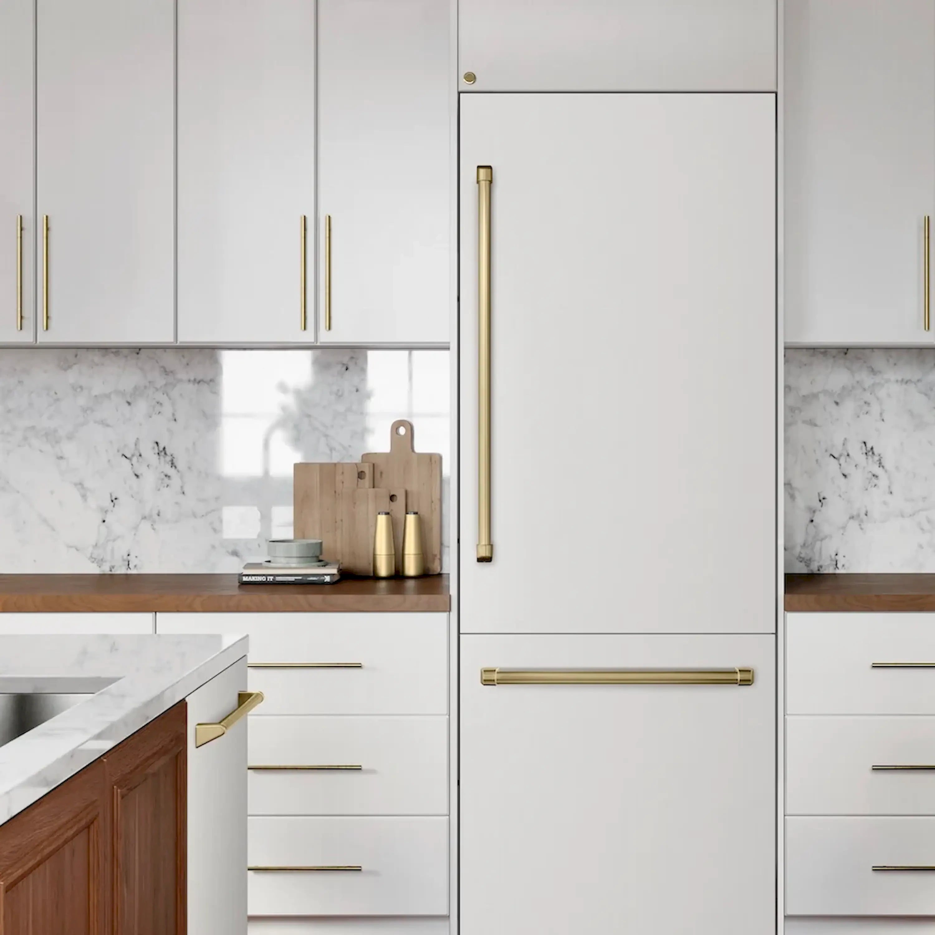 Built-in bottom freezer refrigerator in white with champagne bronze bar handles