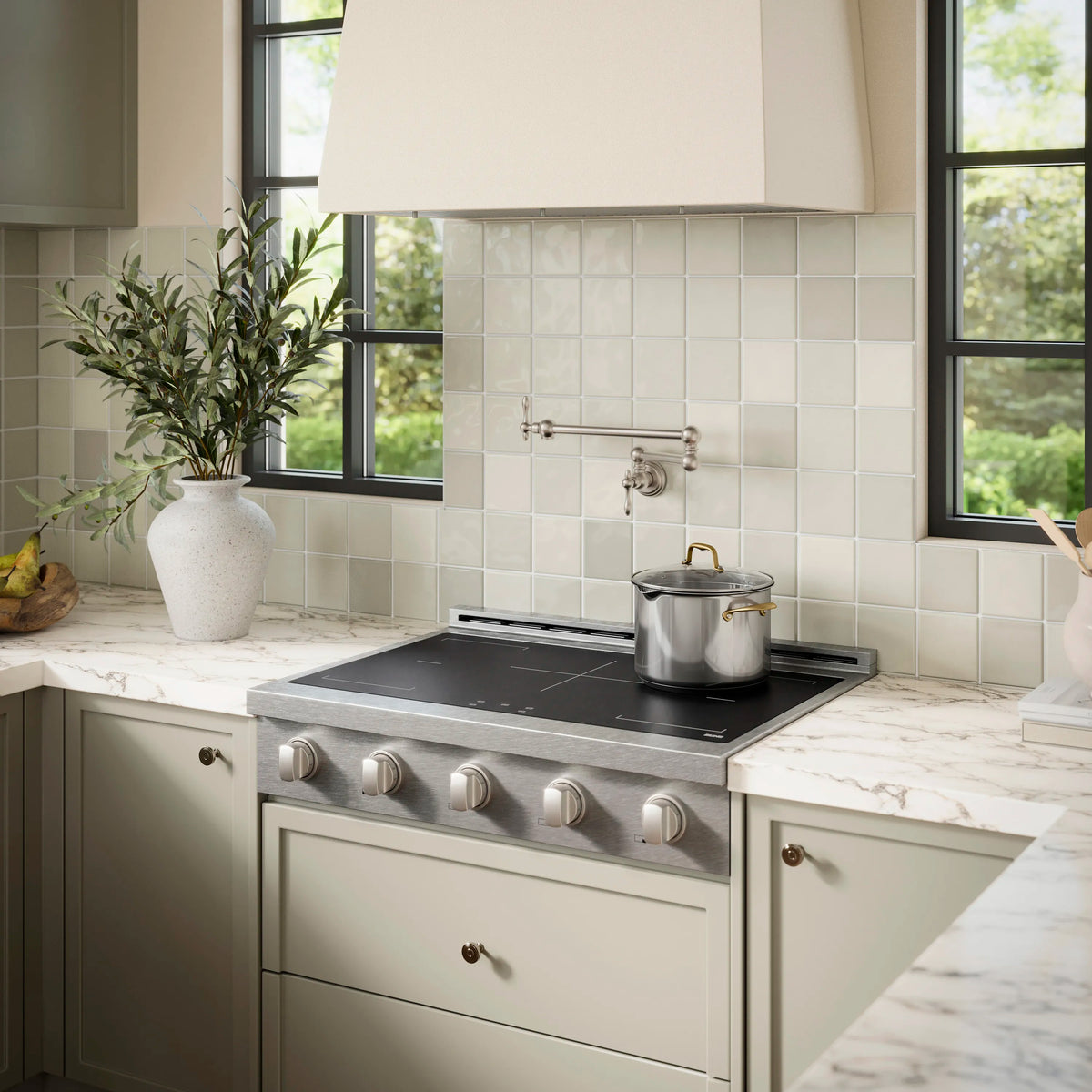 Stainless induction cooktop with black glass surface and five knob controls