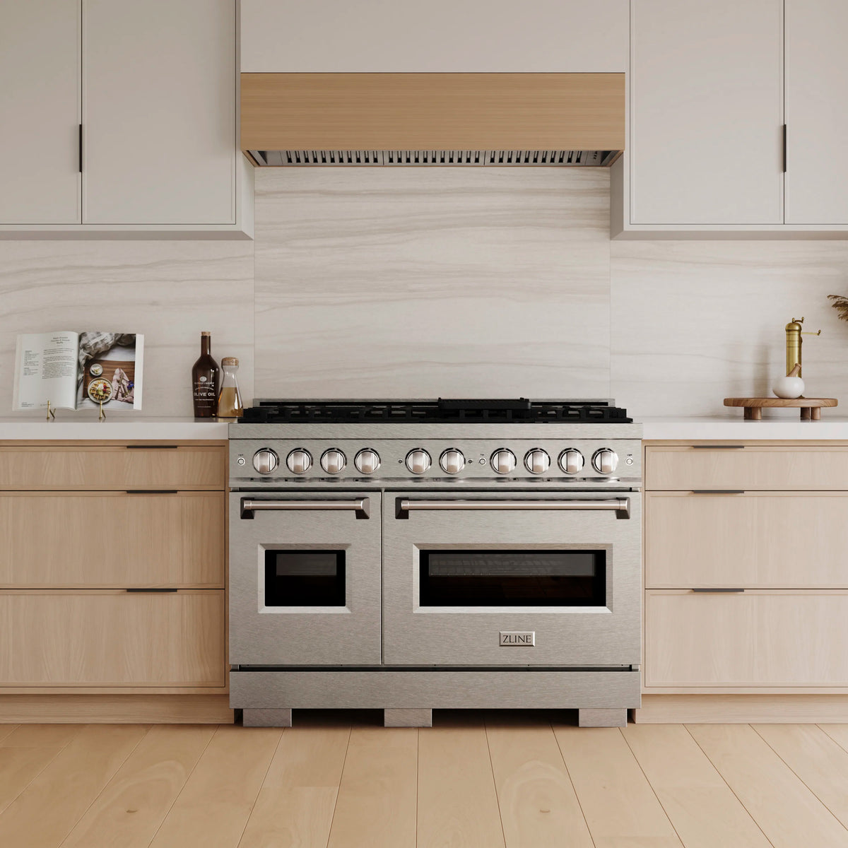 Stainless steel freestanding gas range front view with double ovens and burner knobs