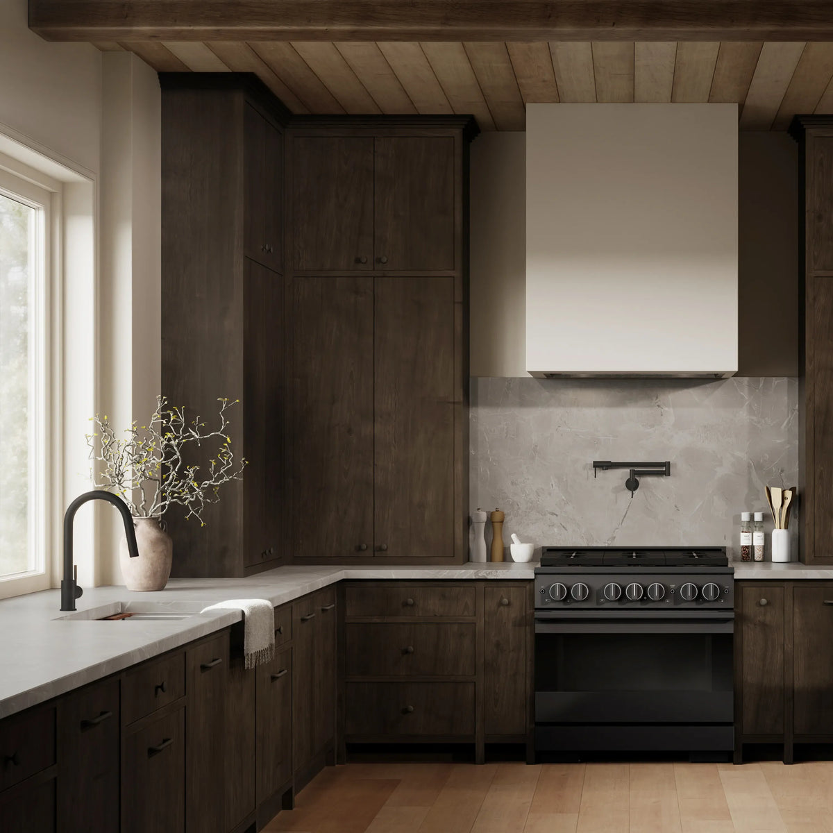 Built-in black stainless gas range in a modern kitchen with surrounding cabinetry