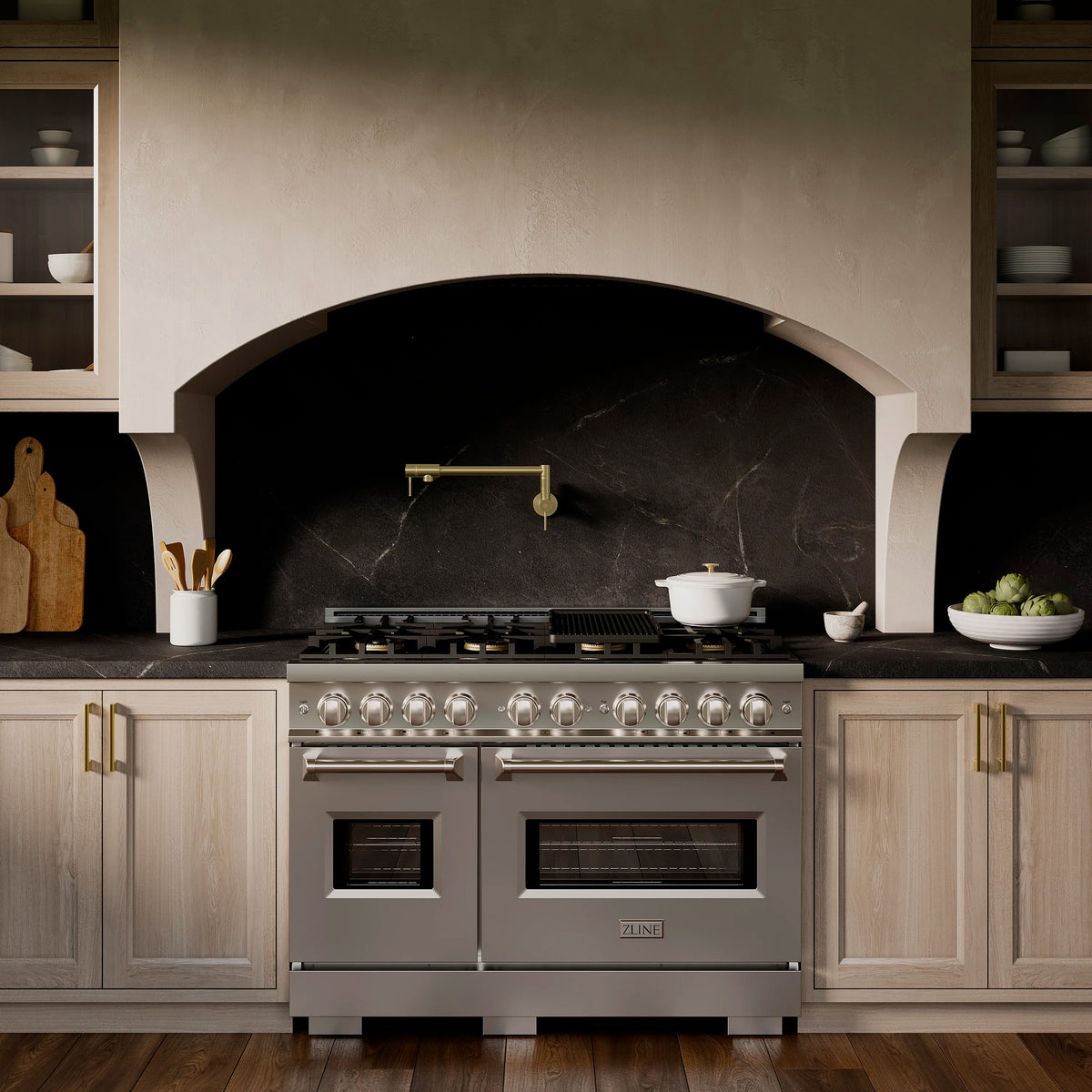 Stainless dual-oven gas range with burner row and two oven doors, front view.