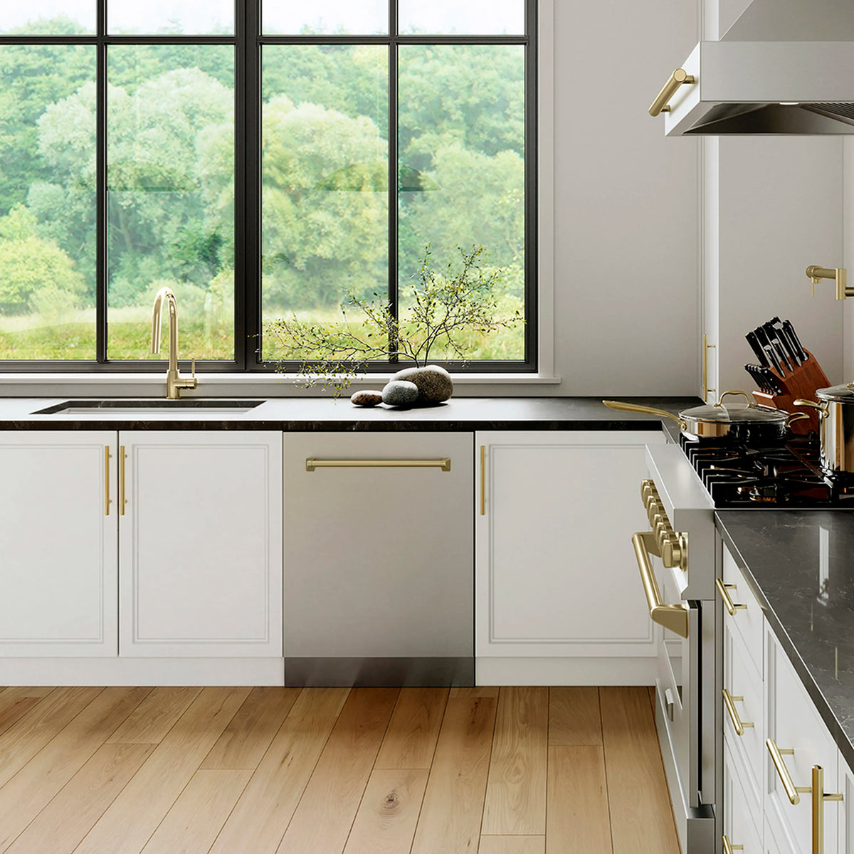 Stainless steel dishwasher with gold handle in a modern kitchen