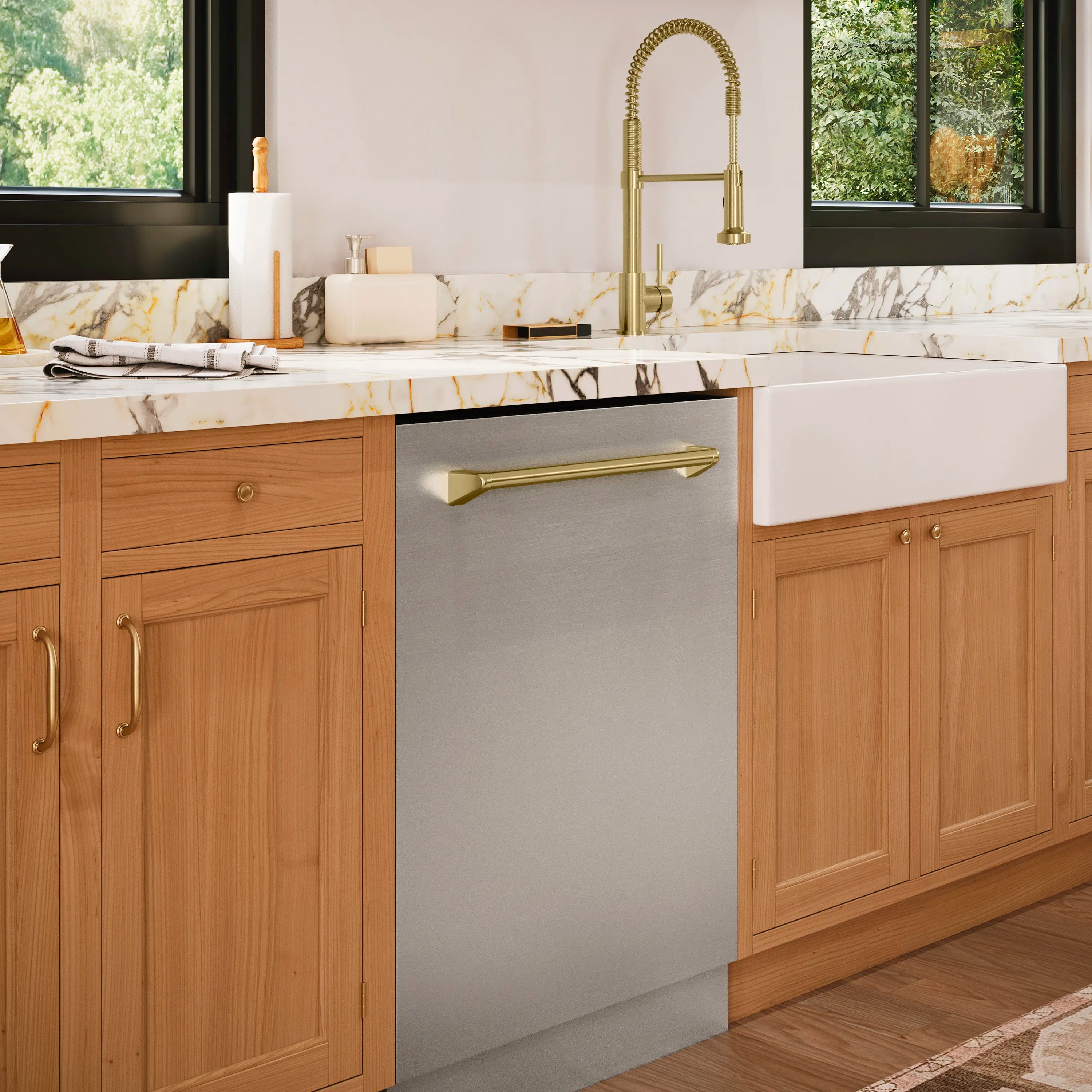 Stainless steel built-in dishwasher with champagne bronze handle, closed door on countertop wall