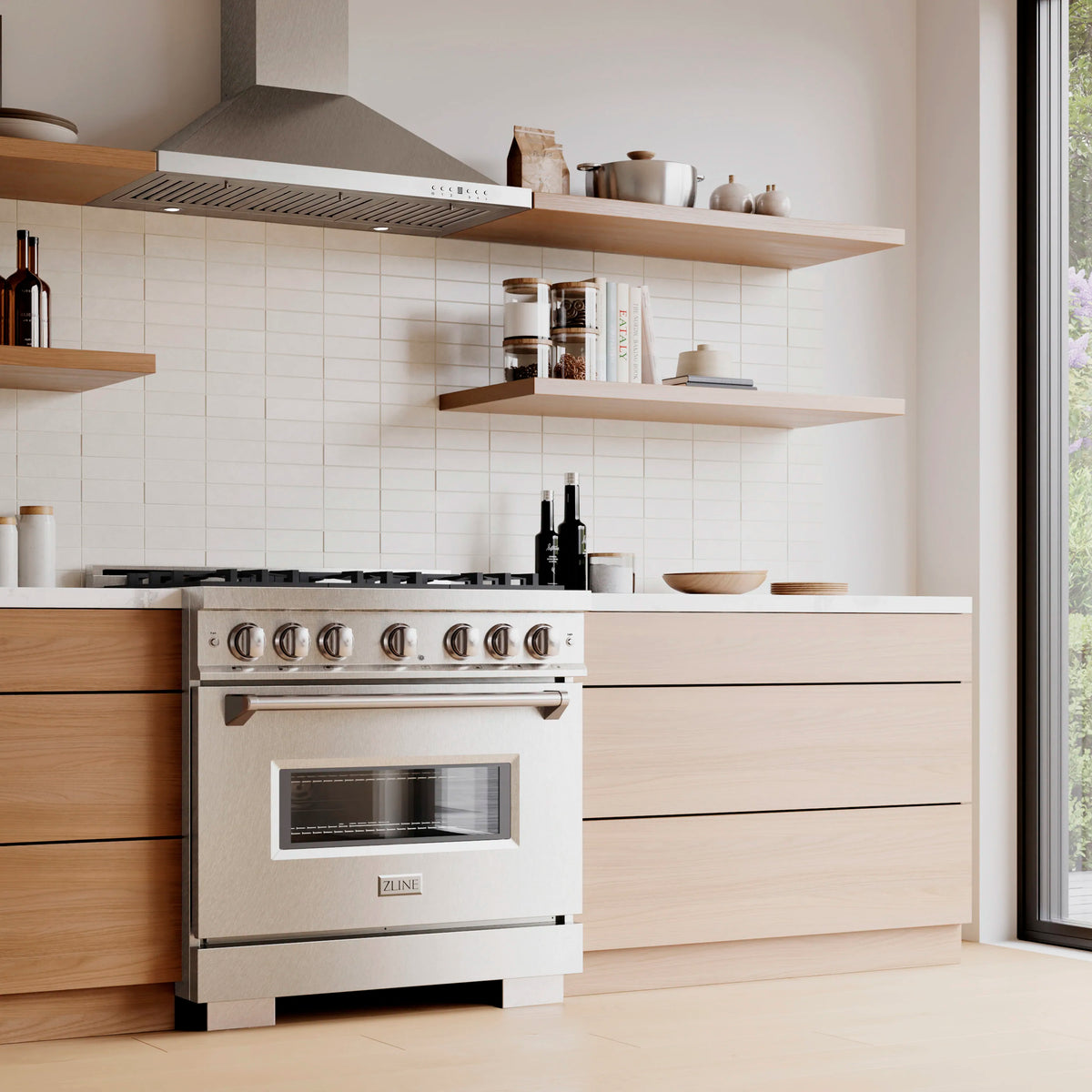 Satin stainless dual fuel range with oven door and control knobs in a white kitchen