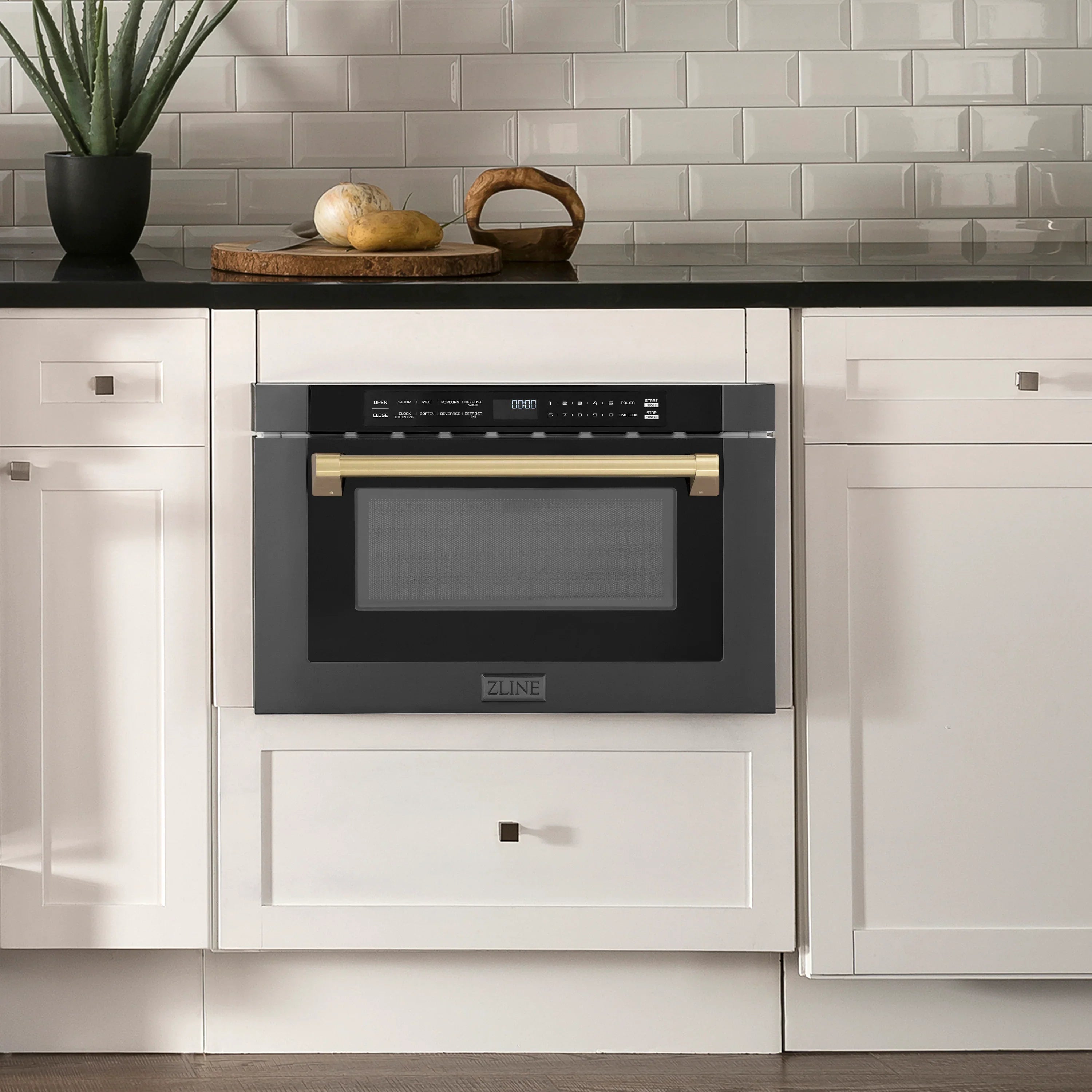 Built-in black oven in kitchen cabinet with champagne bronze handle accents