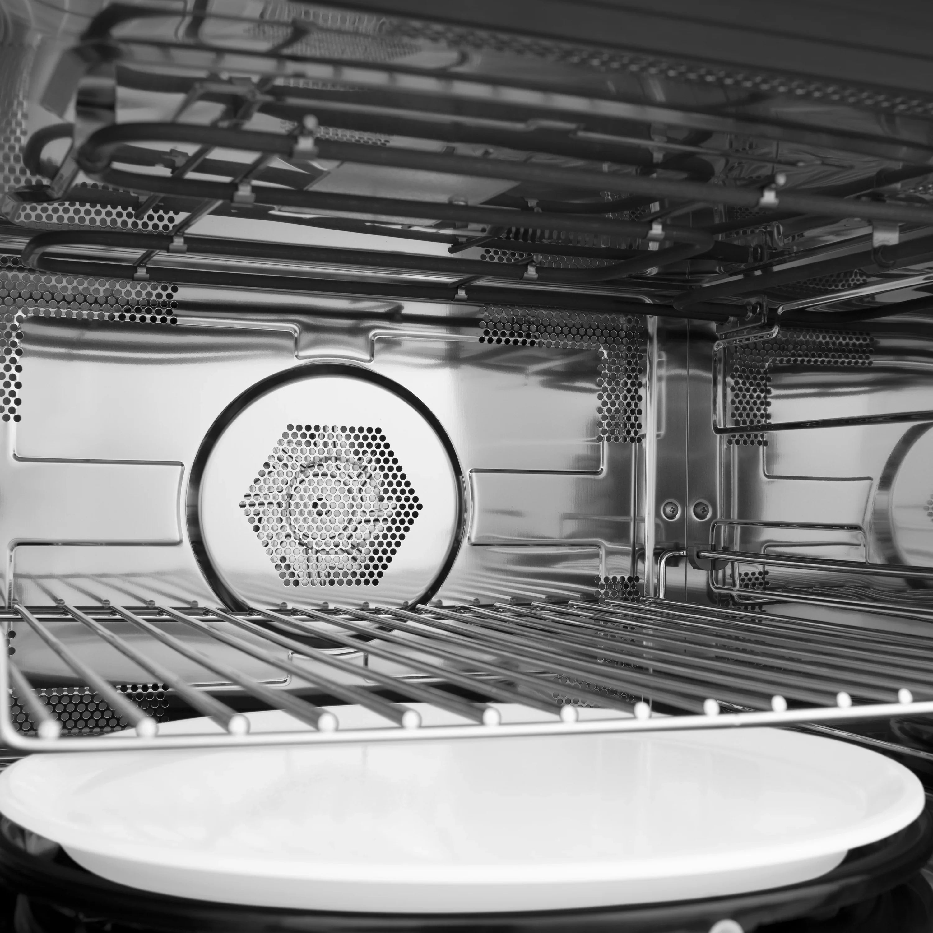 Single wall oven interior with top heating area, racks, and circular convection fan