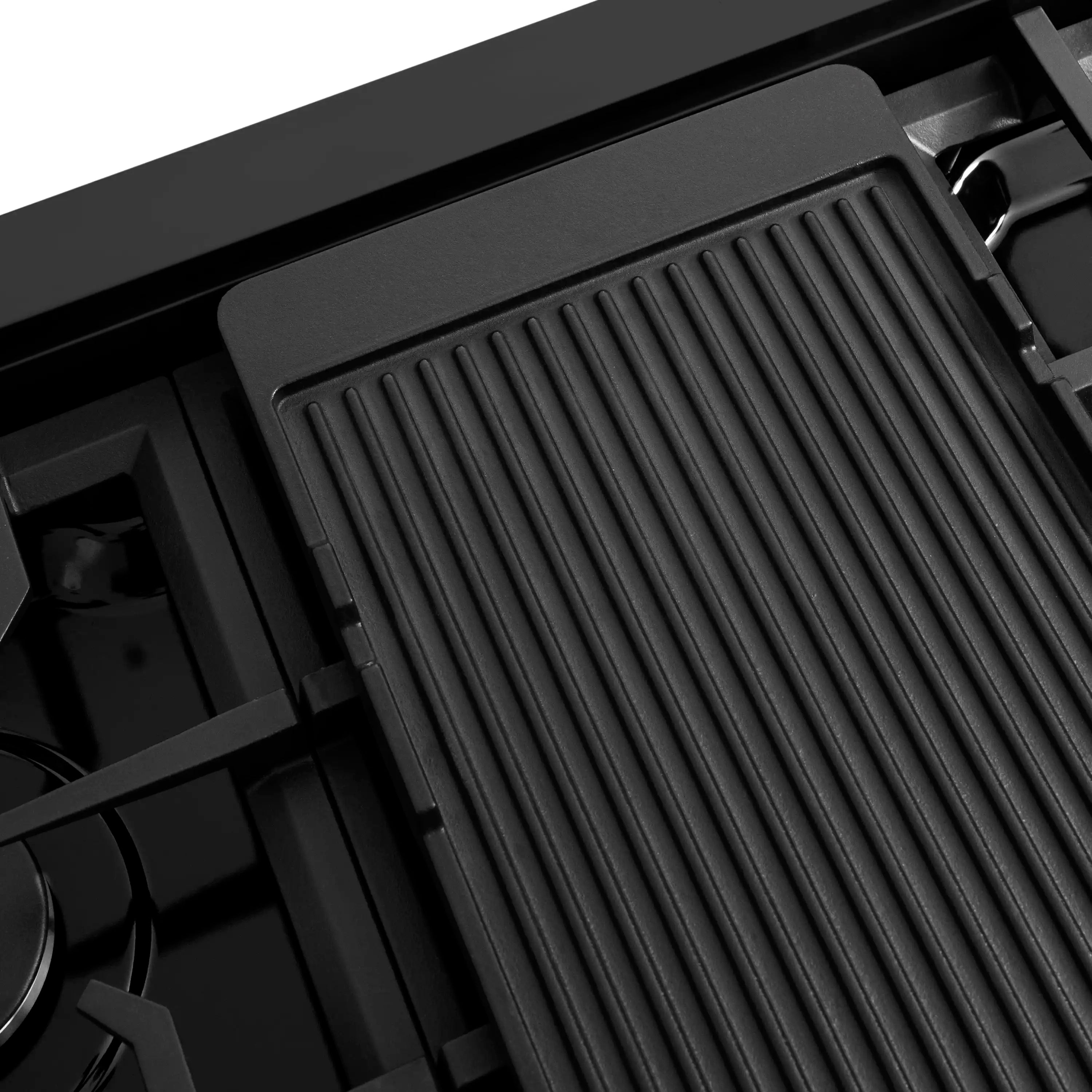 Black gas cooktop burner area with rectangular heat grate cover and surrounding burners