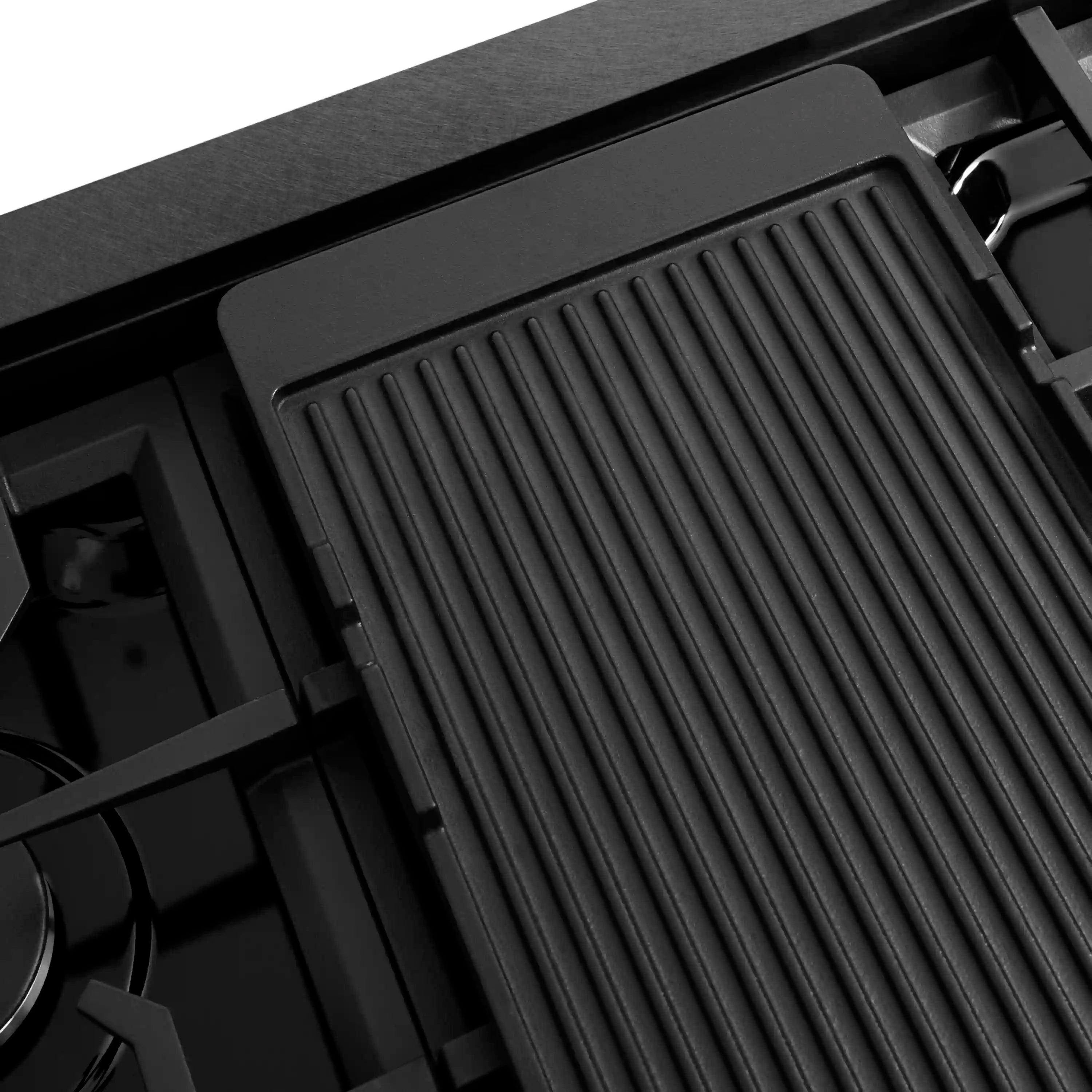 Ribbed black cast griddle insert on a gas rangetop with burner grates