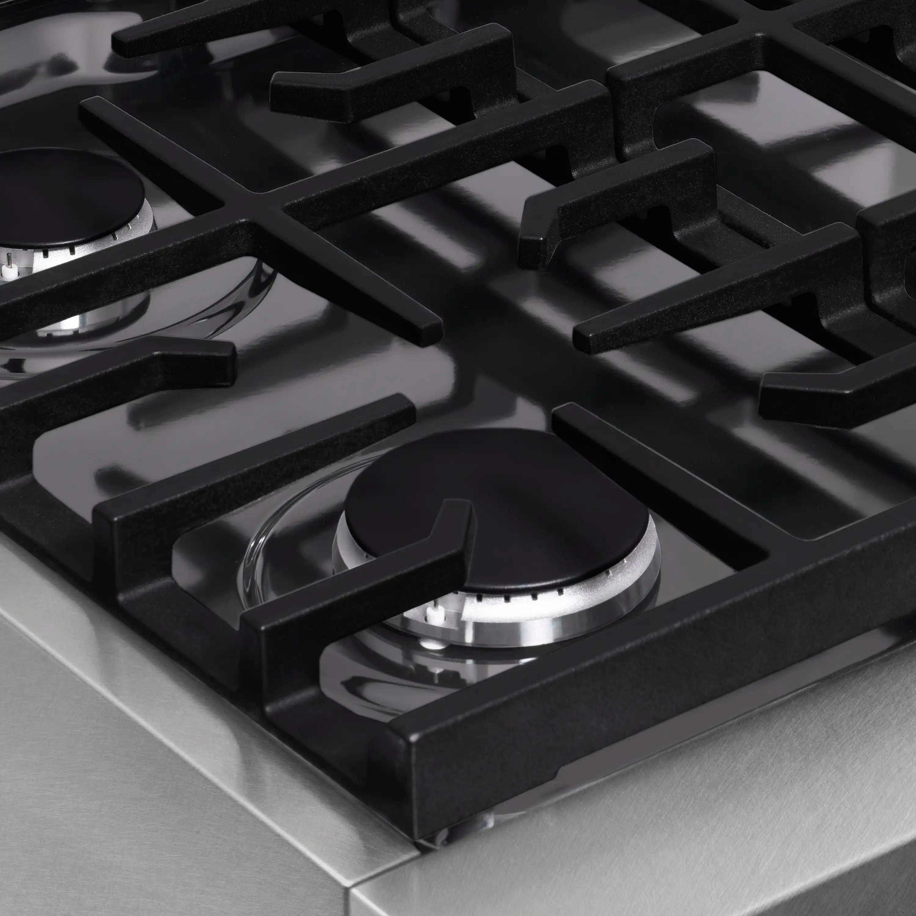 Black cast-iron grate over burner head on satin stainless steel gas rangetop
