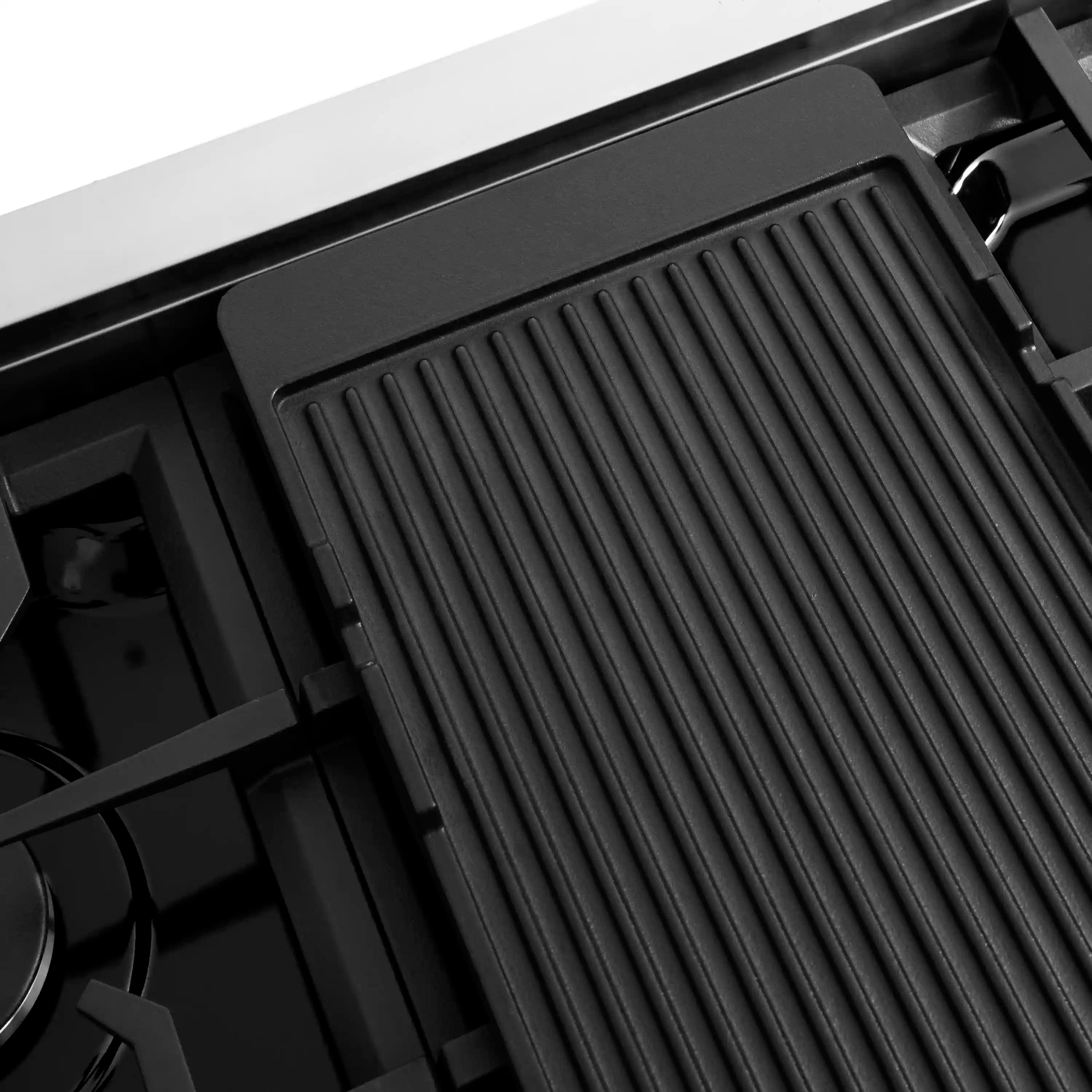 Gas griddle plate on black grate burner section with ridged surface