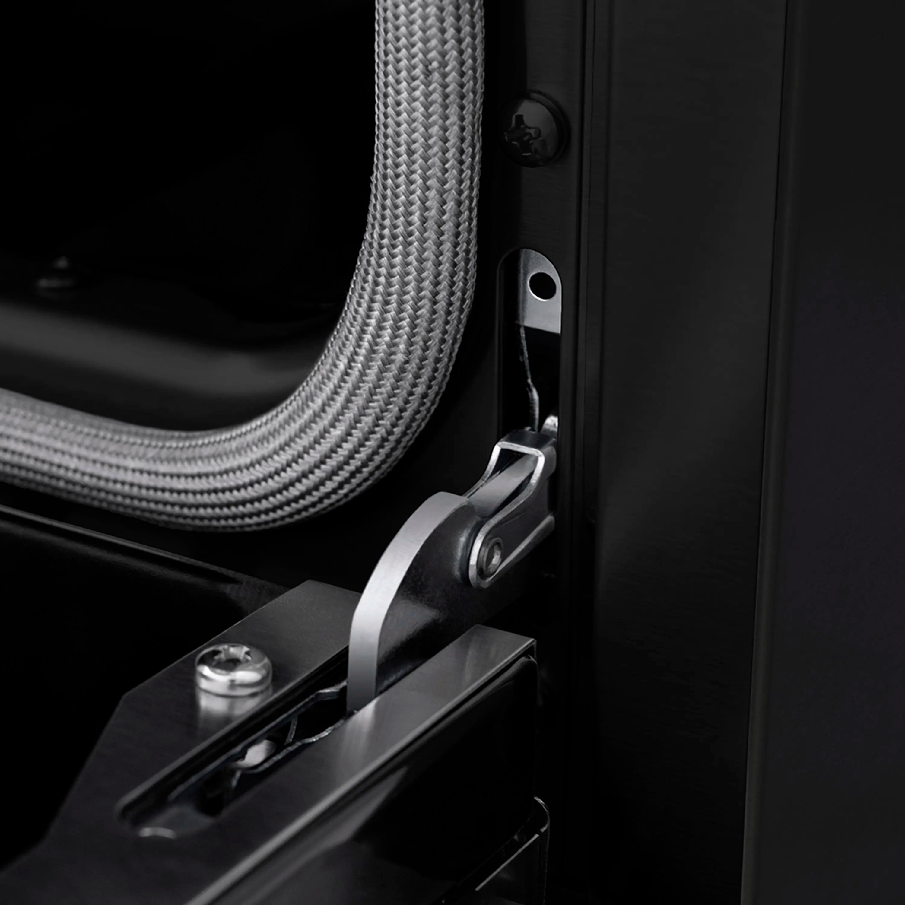 Gas oven handle area with braided gas line and metal mounting bracket