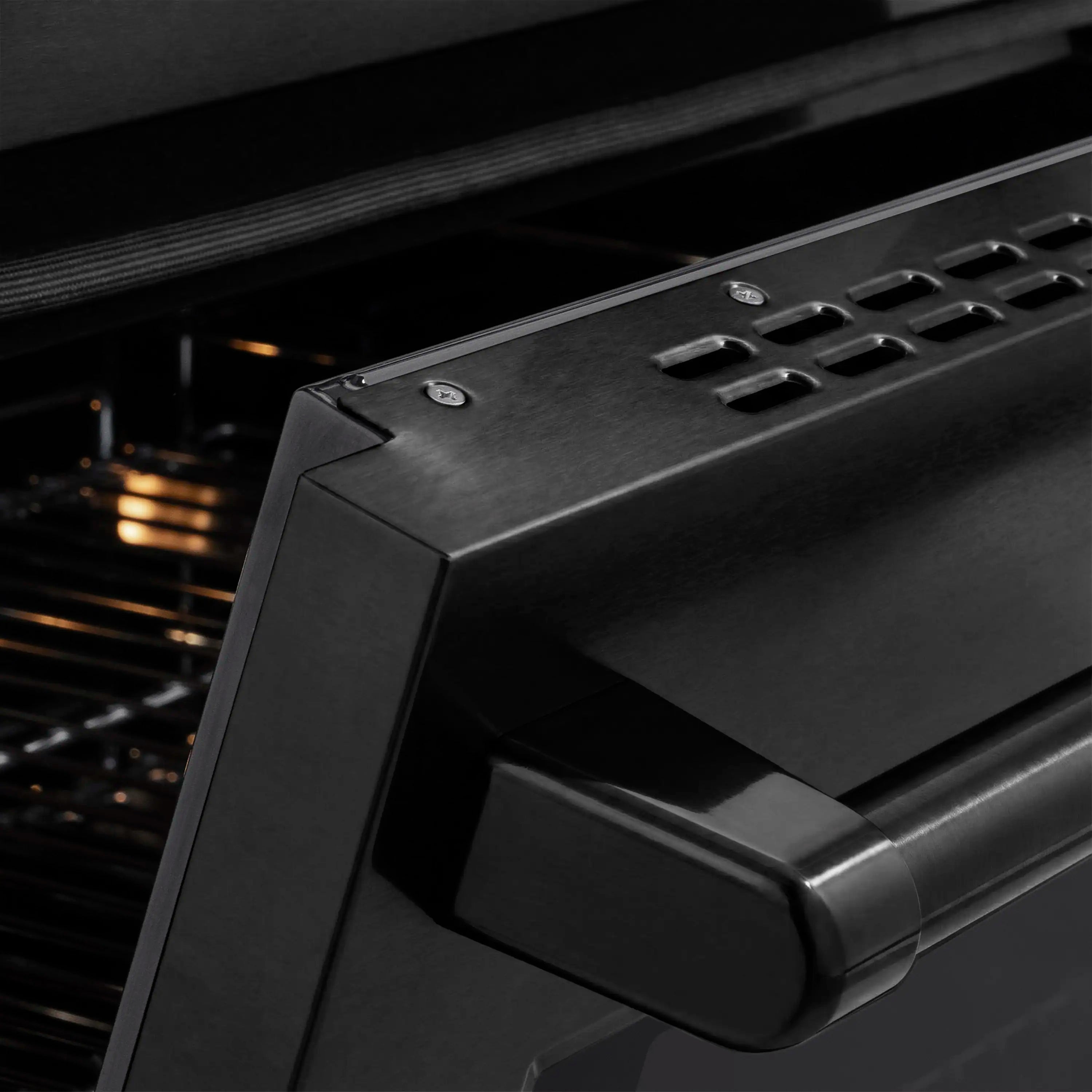 Black stainless oven door handle with control panel edge and metallic finish