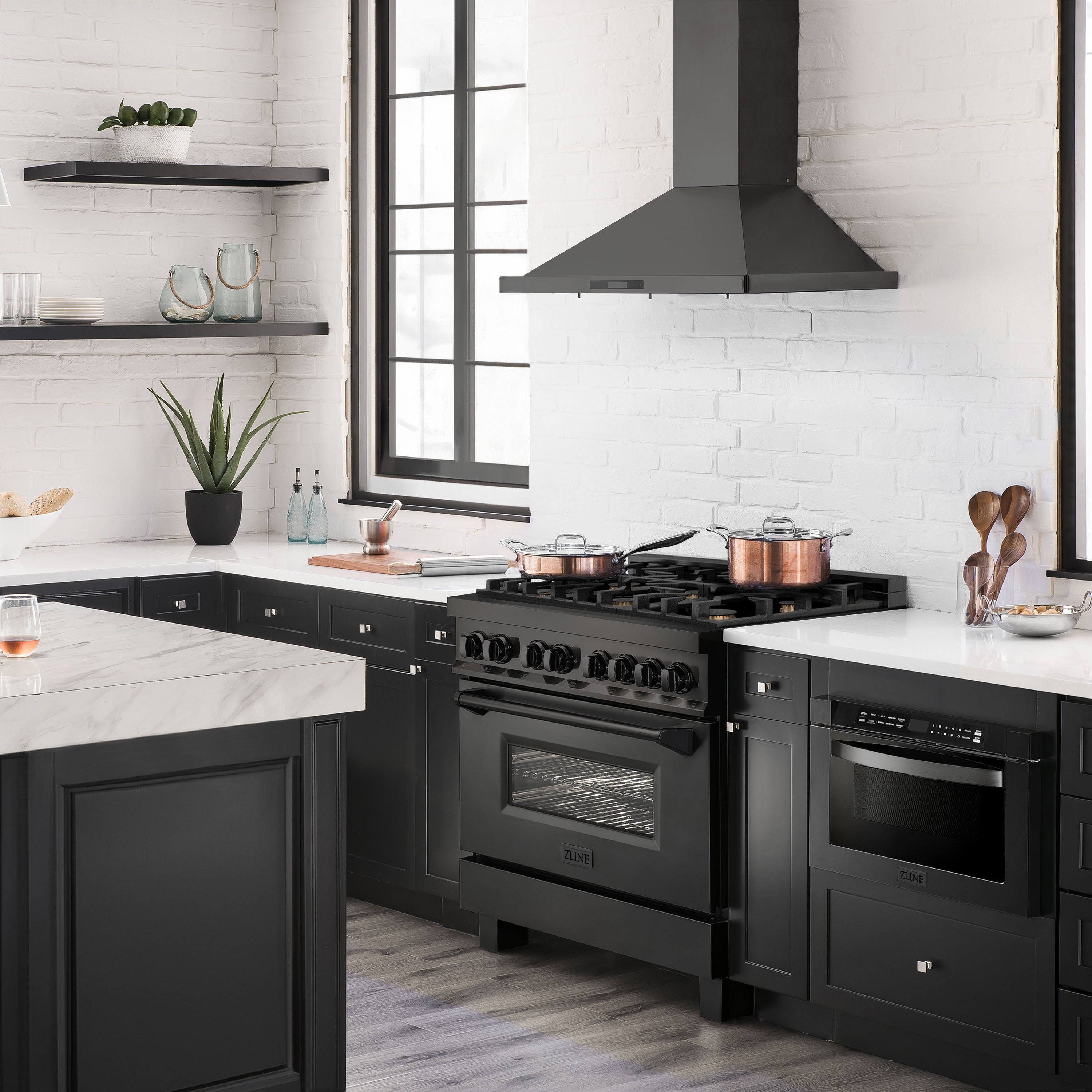 Black dual-fuel range with brass burners and closed oven door in a modern kitchen