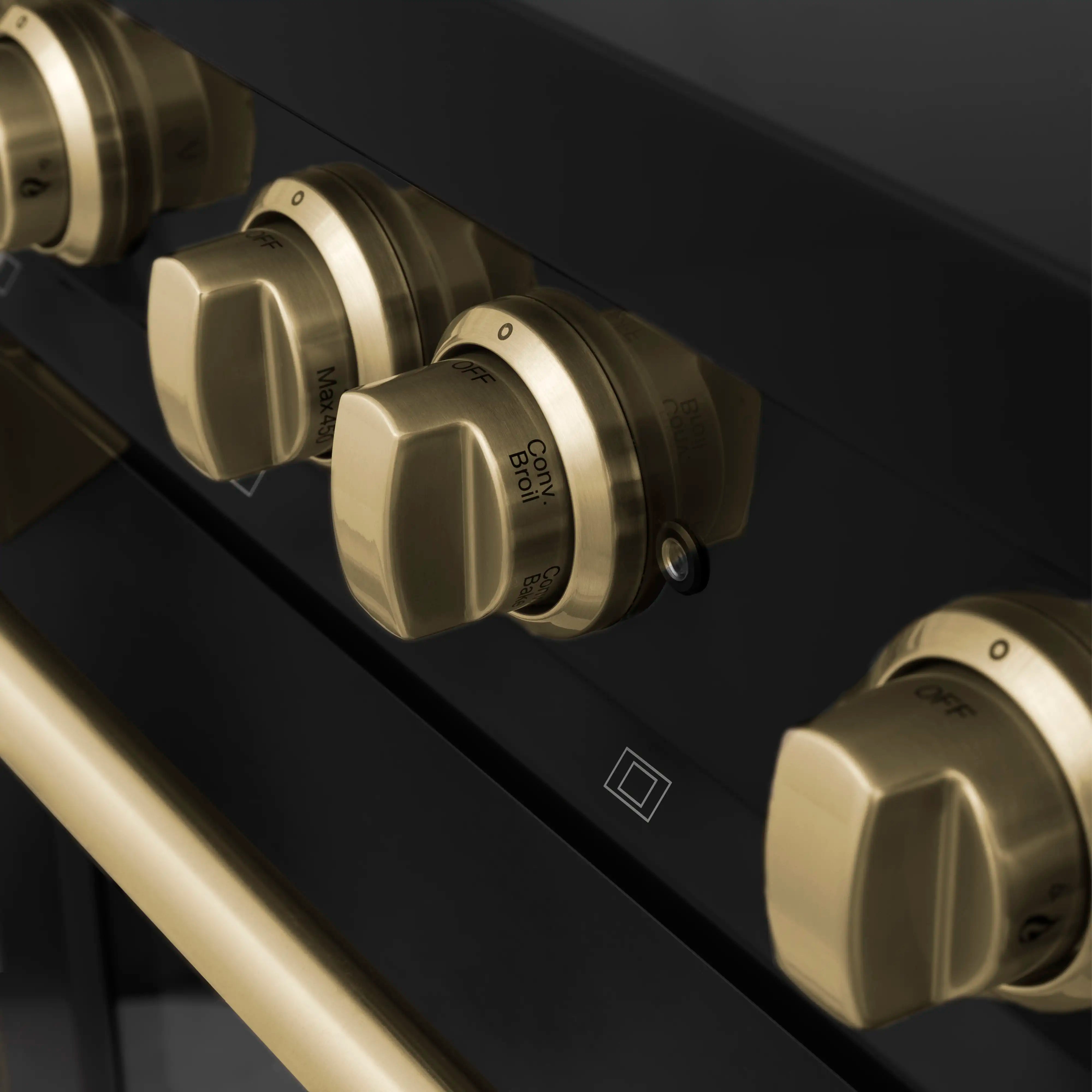 Black dual fuel range control knobs with champagne bronze accents