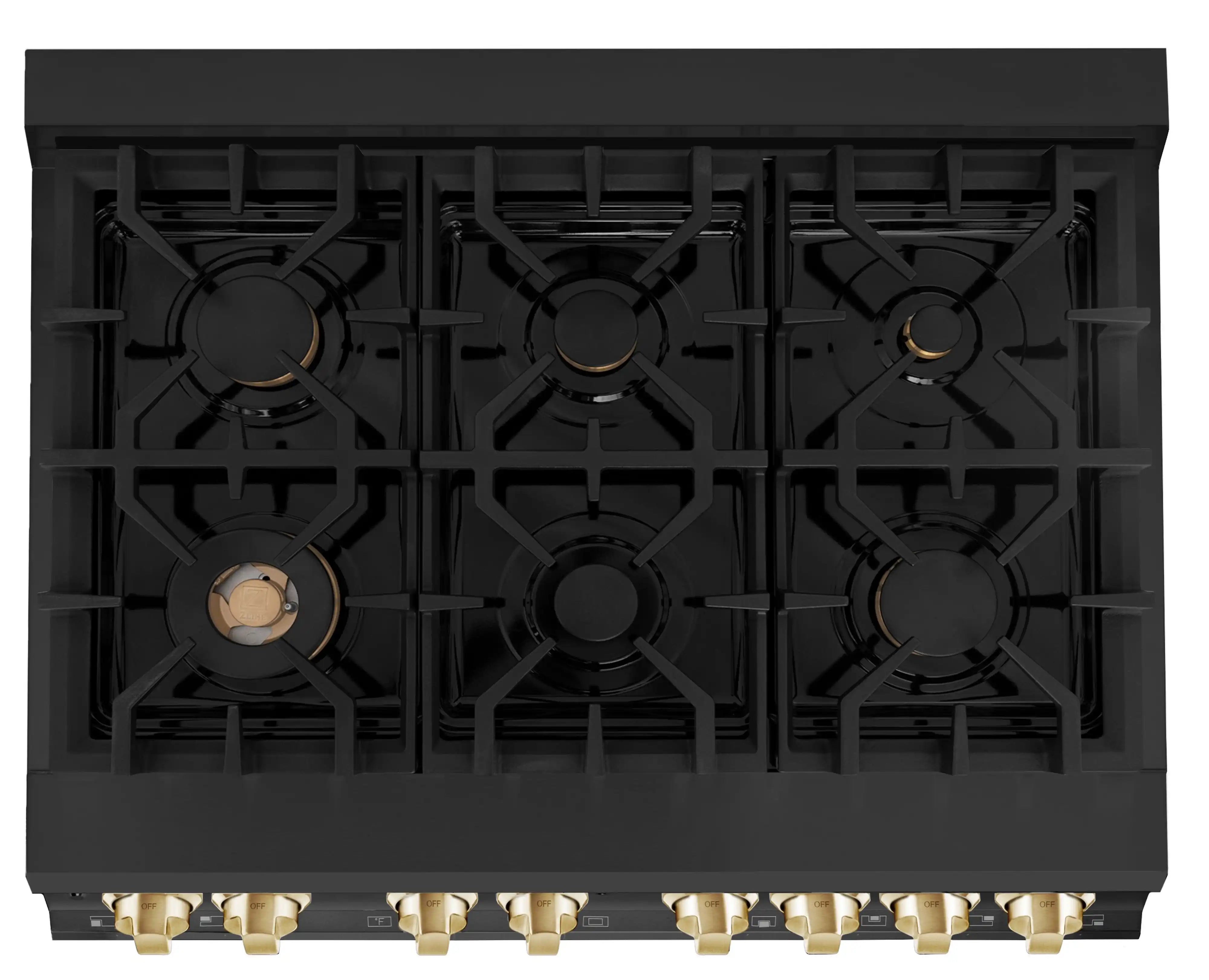 Black cooktop burner grates with gold gas valve accents on back panel