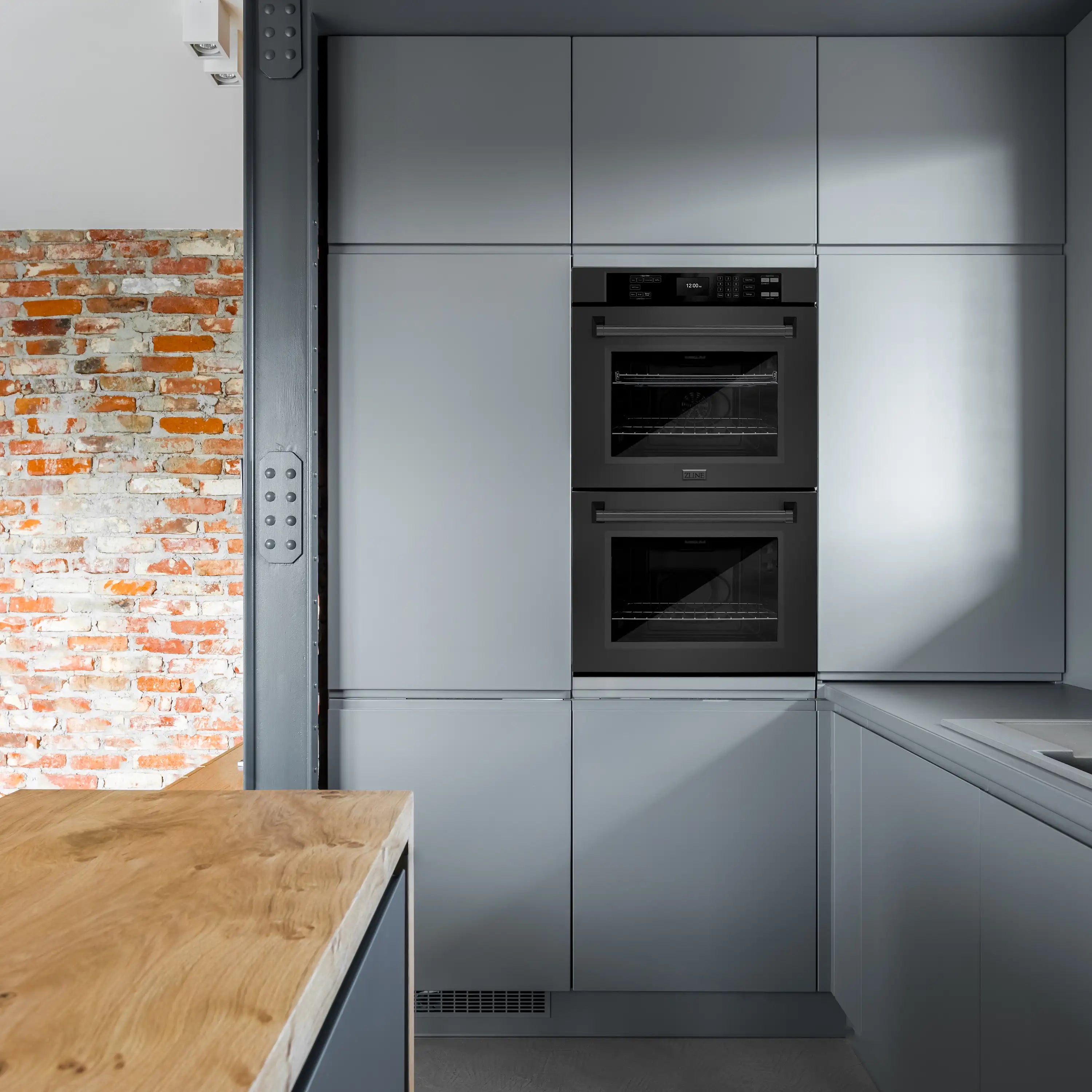 Black stainless built-in double wall oven with two glass doors in a kitchen cabinet