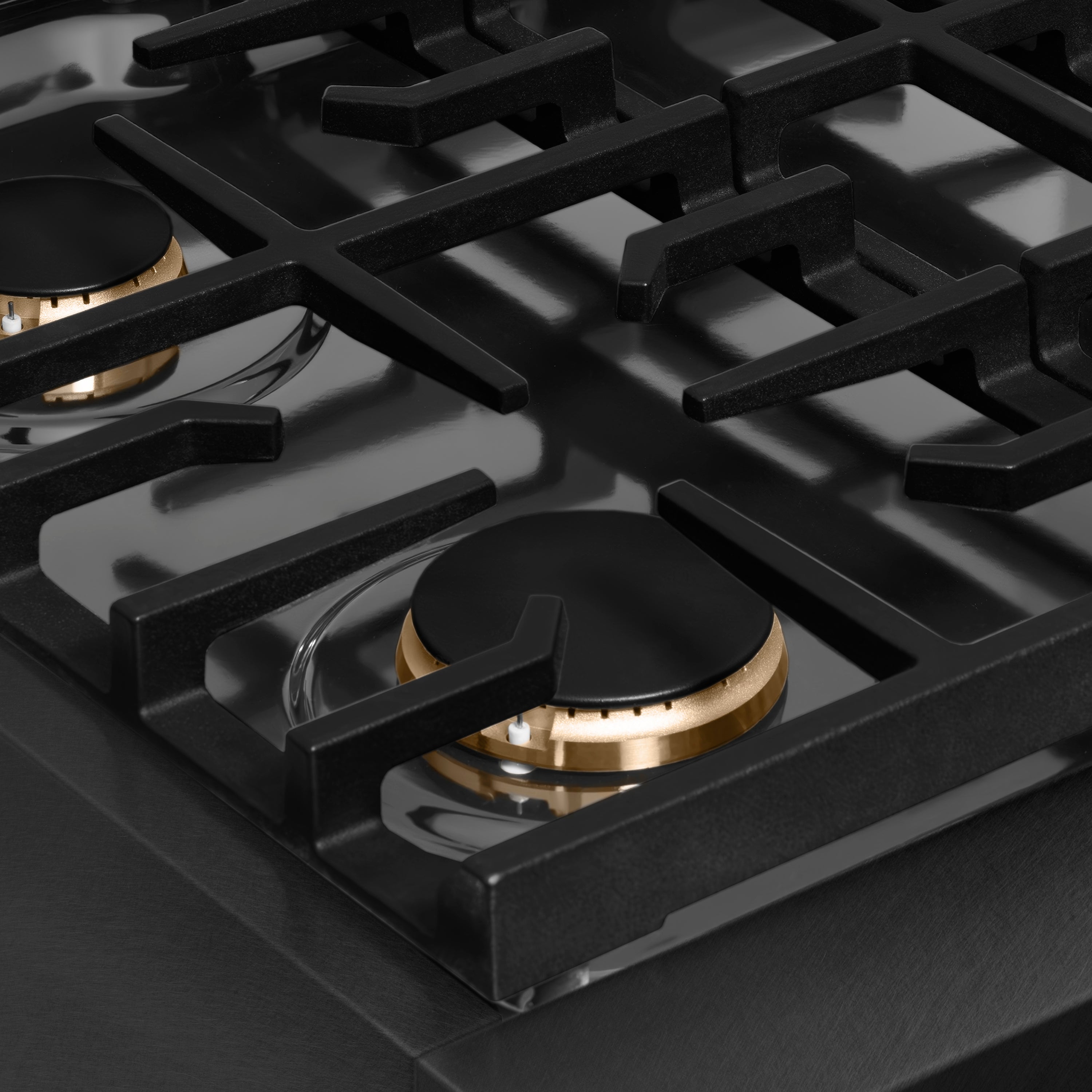 Black cast-iron grates over burners on a black satin gas cooktop