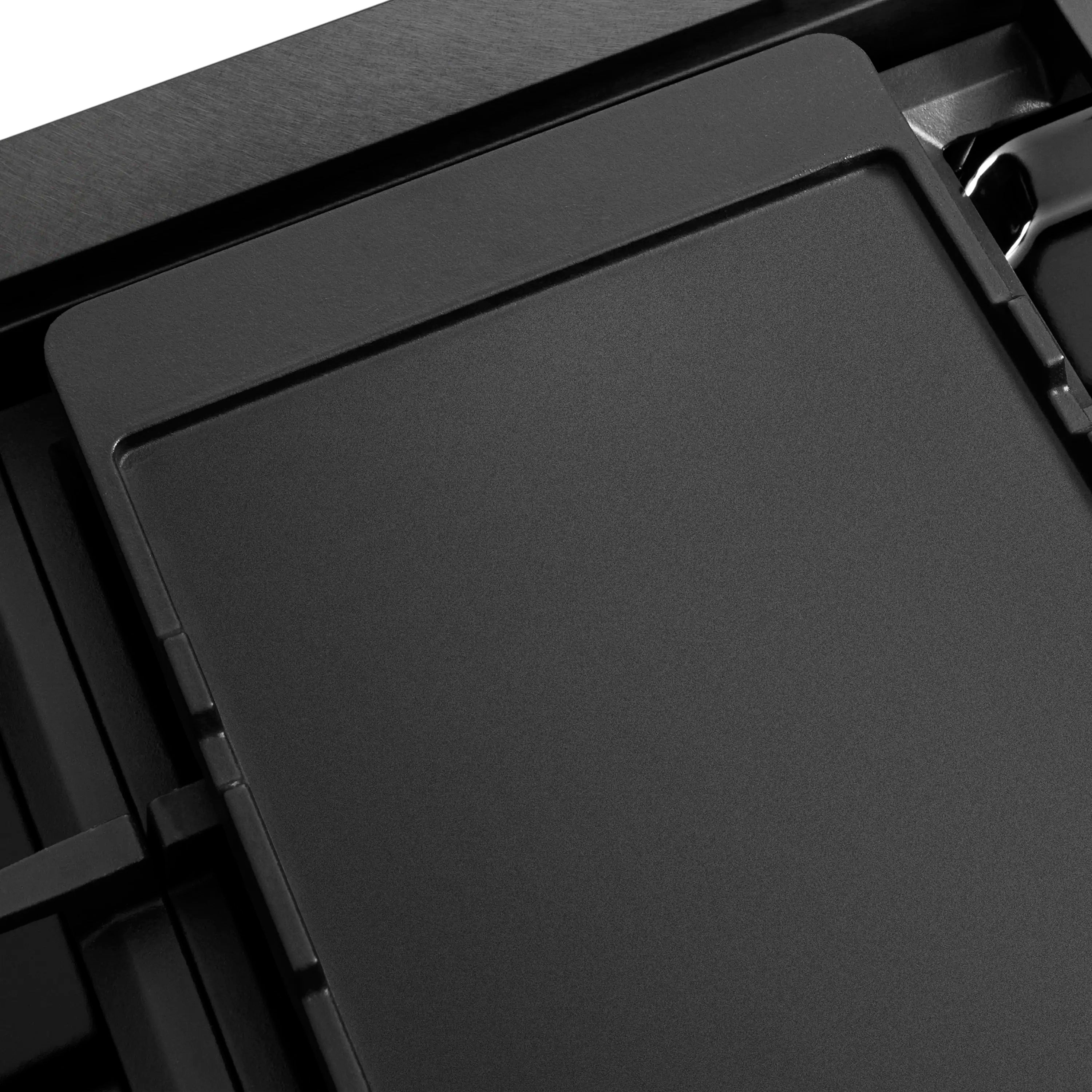 Black griddle insert with smooth cooking surface and fitted cooktop frame