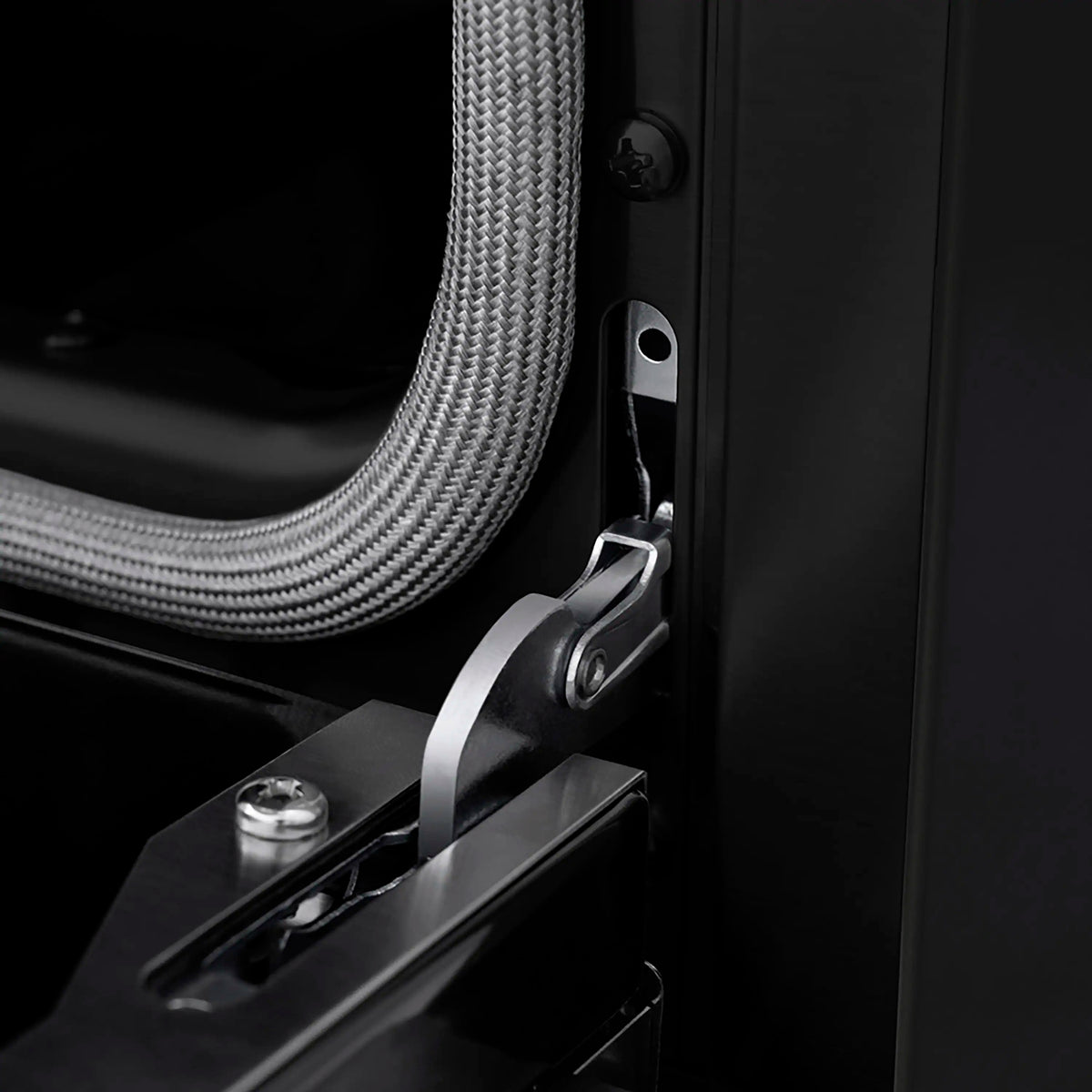 Range door hinge and bronze-trim handle lever on black panel