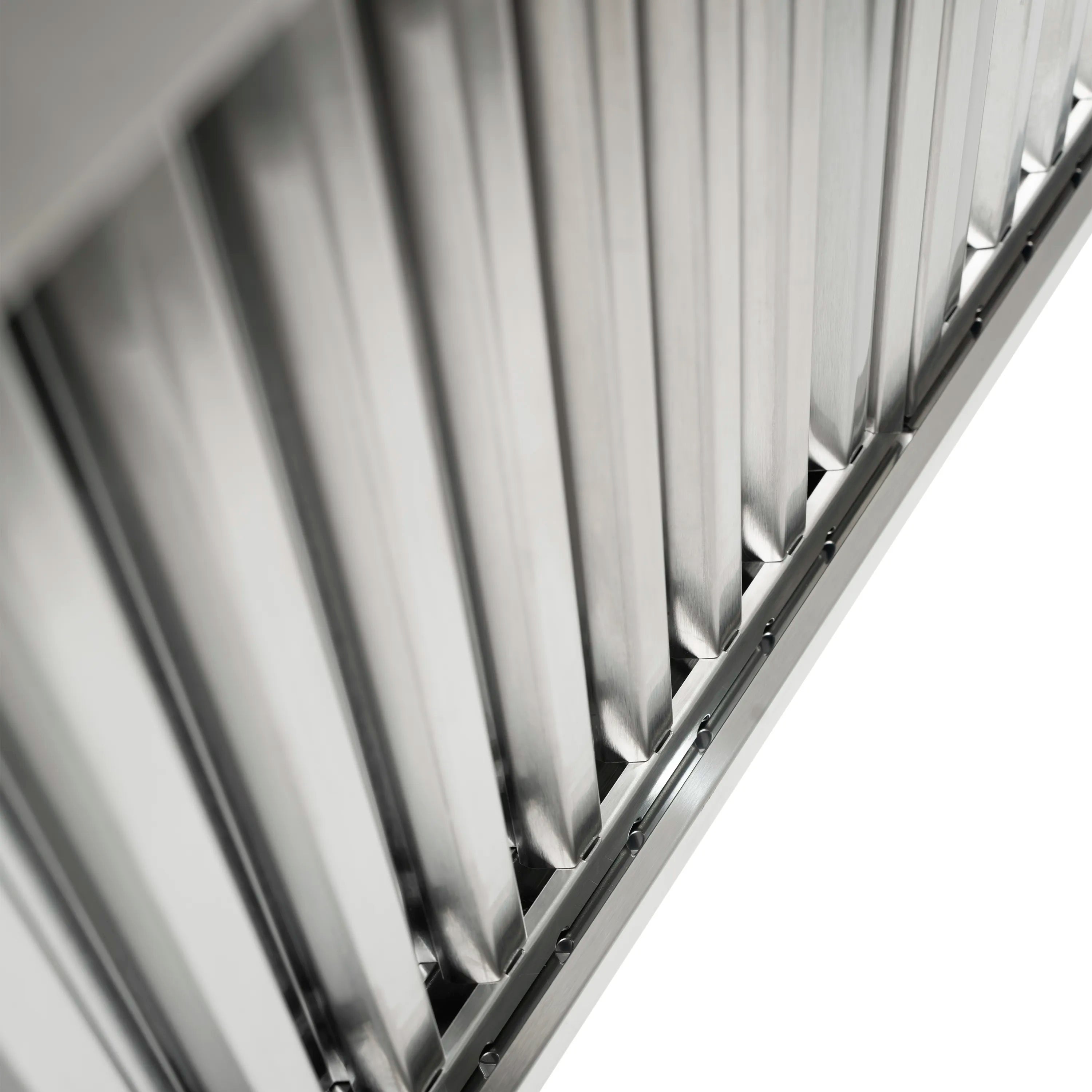 Metal vent baffle panel with closely spaced vertical louvers inside the hood