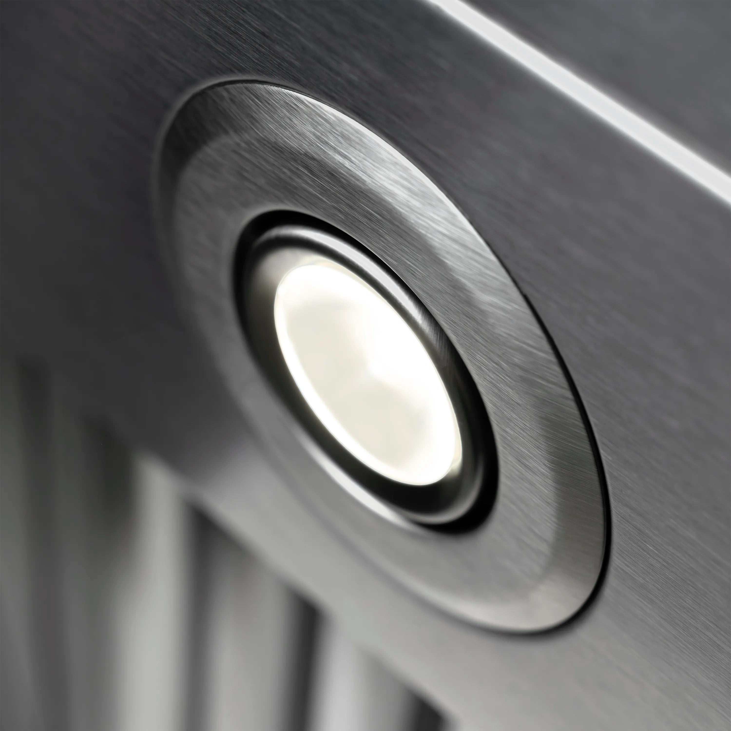 Stainless steel hood light button with circular lens detail